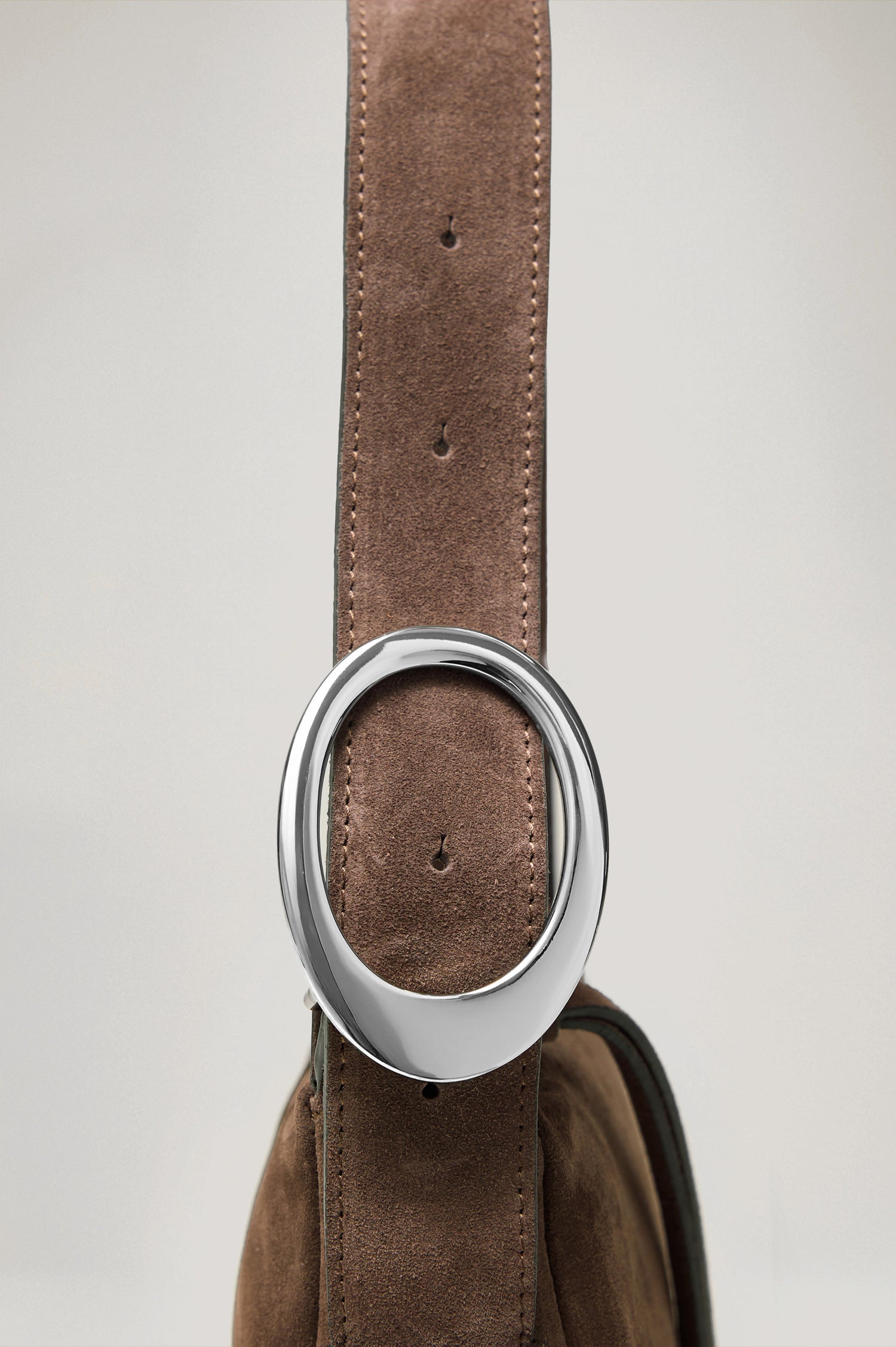 Lucca Shoulder Bag in Suede With Adjustable Strap and Polished Silver Buckle, Microsuede Lining, and Snap Button Interior Slip Pocket in Espresso Suede Colorway - Side View Close Up Featured