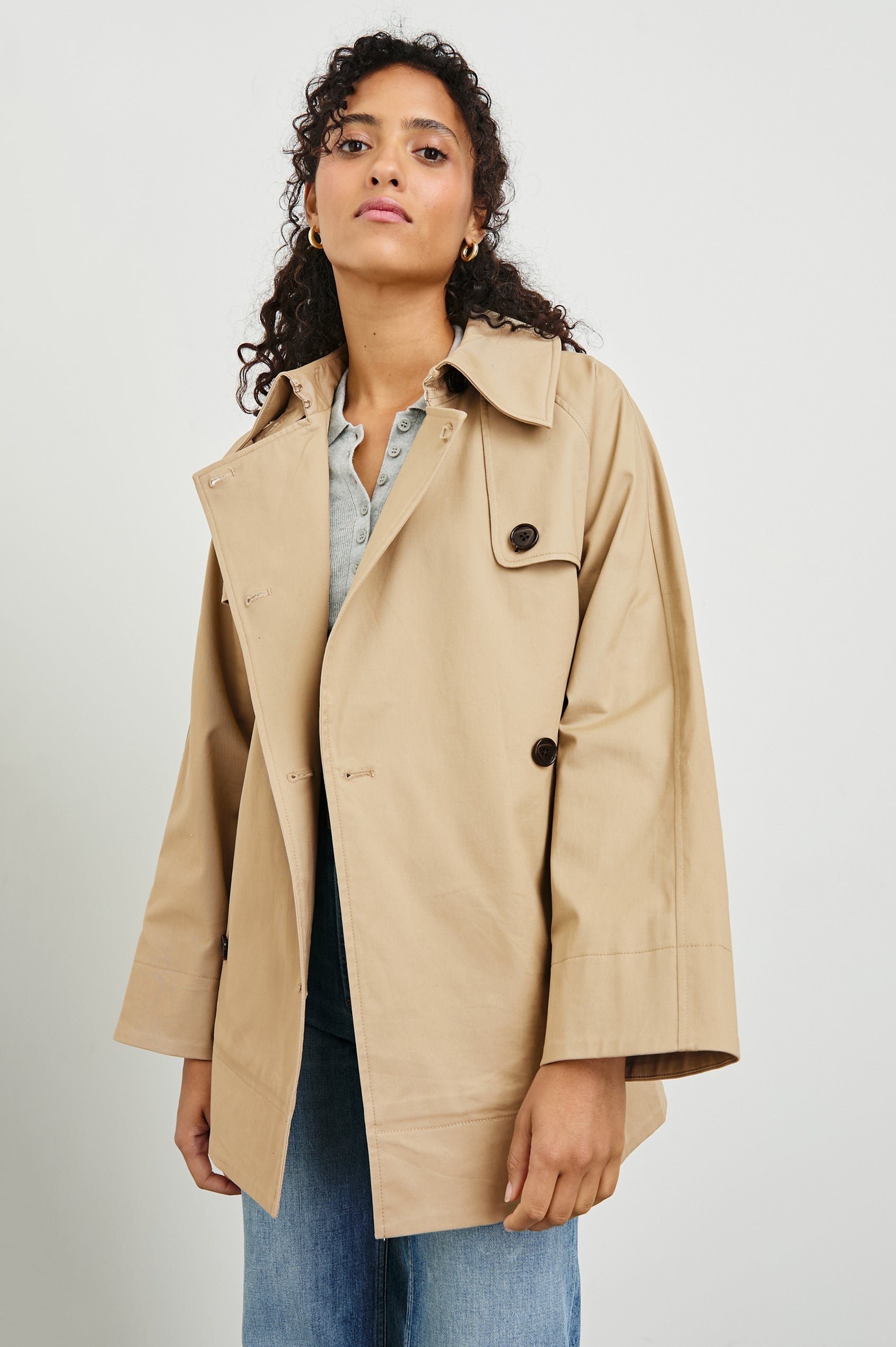 Lucien Trench Jacket with a Belt at the Waist, Button Closure and Two Front Pockets in Taupe Colorway with Dark Brown Buttons - Front View Featured on Model