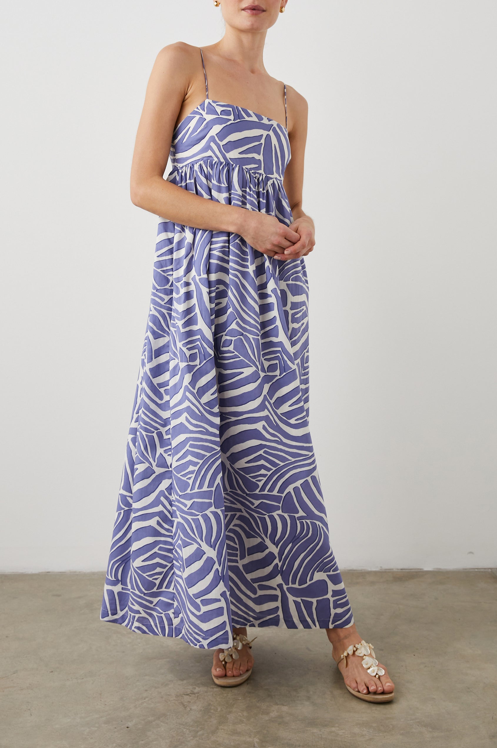 Lucille Sleeveless Maxi Dress with Adjustable Spaghetti Straps, a Square Neckline, and Shirring at the Back in Island Waves Colorway, a Purple and White Print - Front Full Body View Featured on Model  