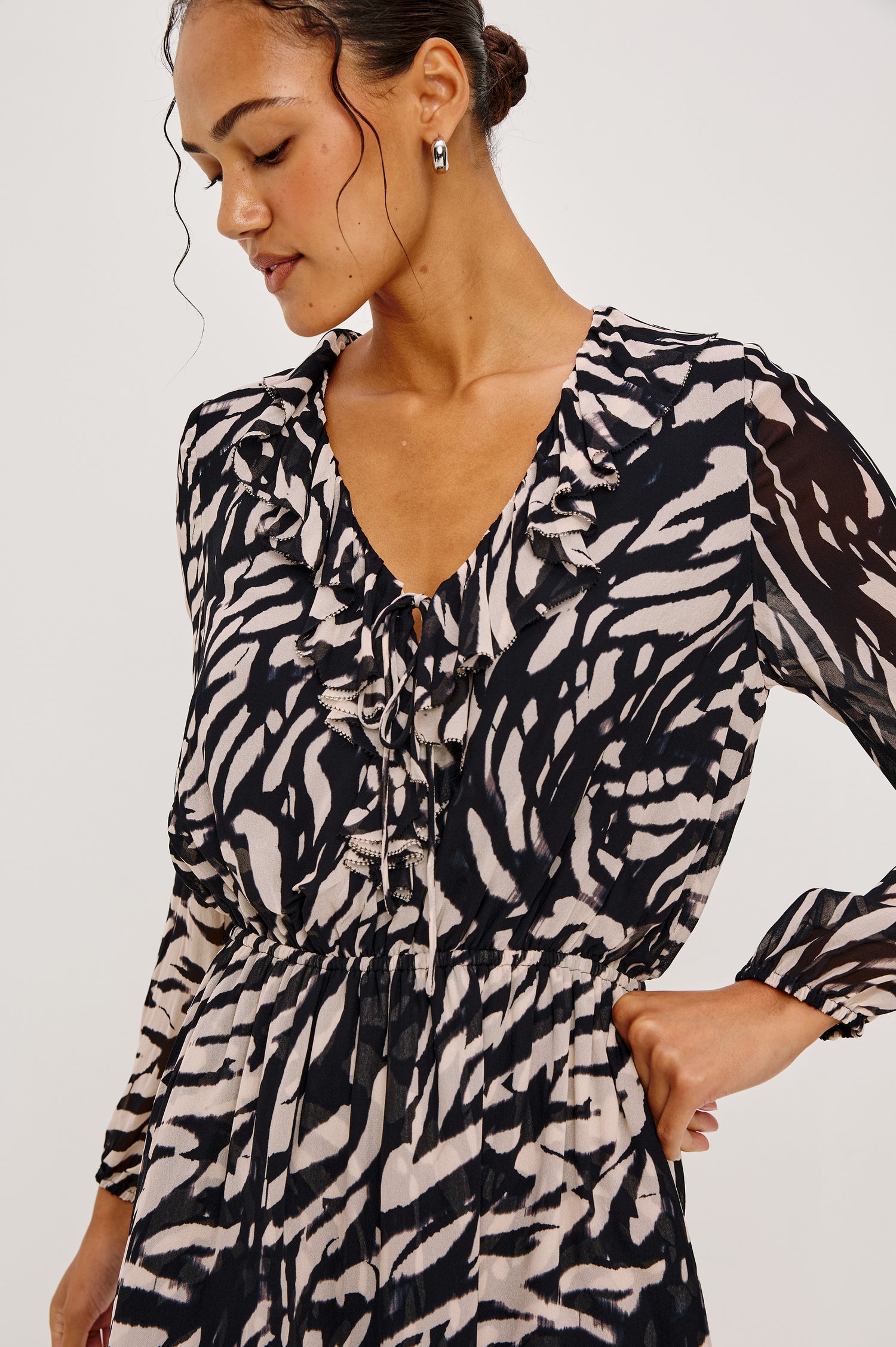 Lucresia Mini Dress in Chiffon With a Ruffle V-Neckline With Self-Ties, Long Lantern Sleeves, Elasticated Waist, and Lined Body in Ivory Tiger Stripe Colorway - Upper Body Front View Featured on Model