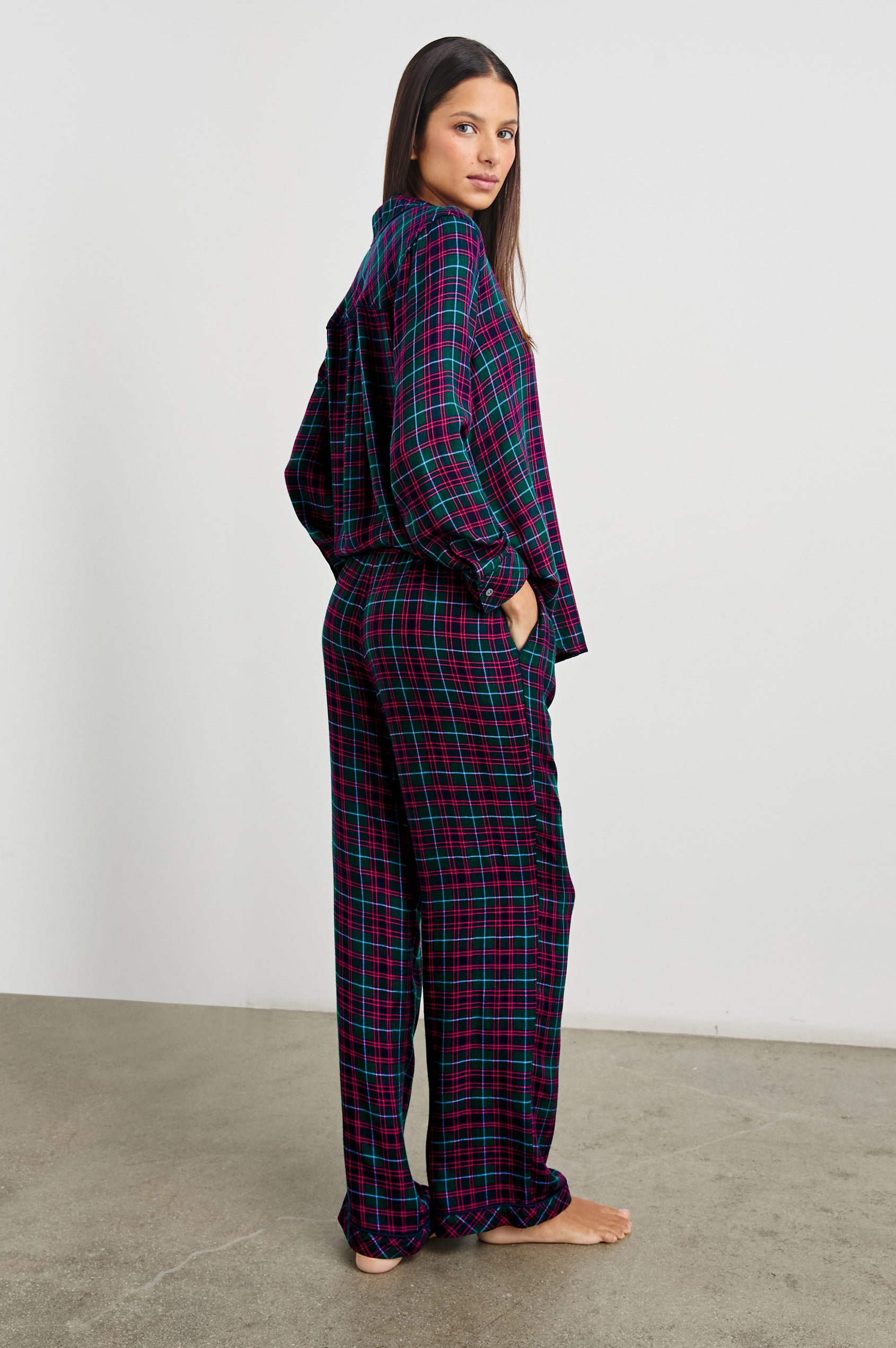 Luna Pajama Set with a Long Sleeve, Button Up, V Neck Top with a Chest Patch Pocket and Pants with Two Front Pockets in Evergreen Fuchsia Ice Colorway, a plaid - Back Full Body View Featured on Model  