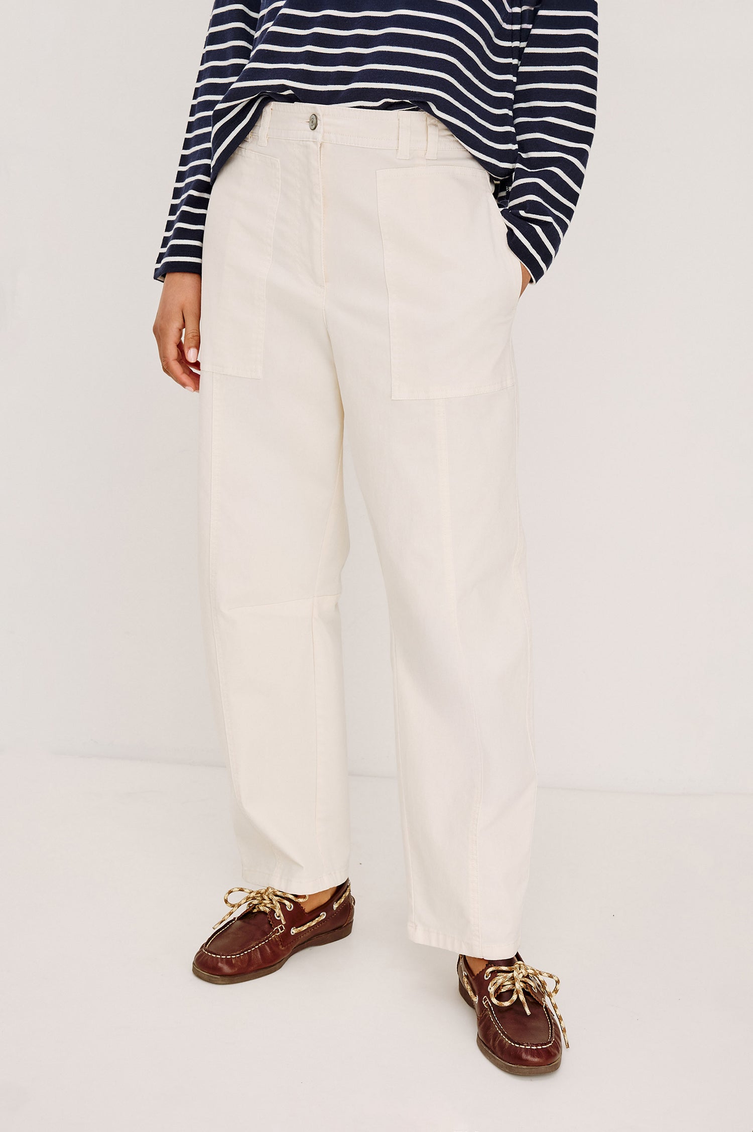 Lunar Pant in Stretch Corduroy With Relaxed Straight Legs Zip-Fly Closure Belt Loops Seam Detailing Carpenter-Style Side Pockets and Back Pockets in Bone Colorway - Lower Body Front View Featured on Model