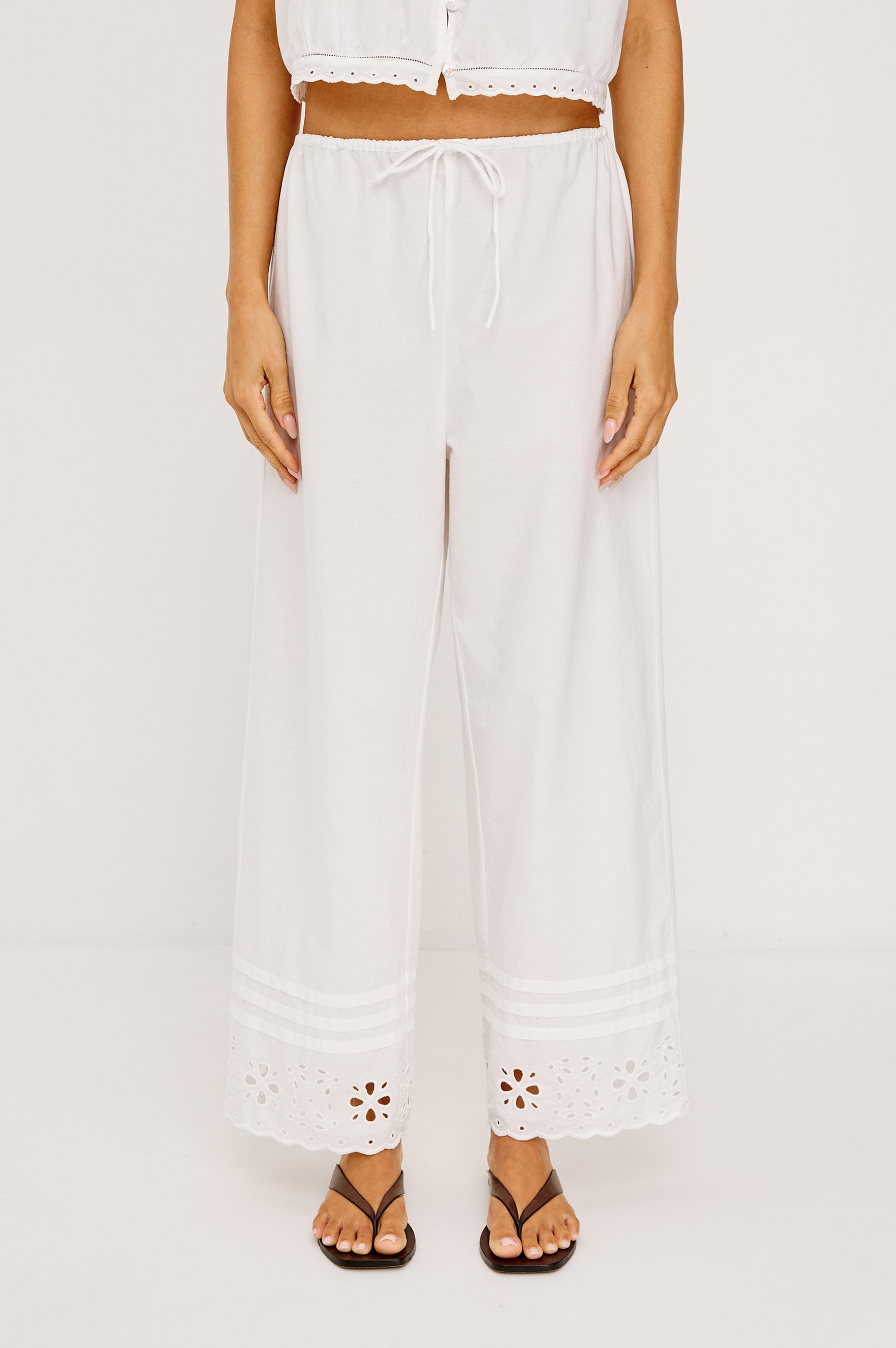 Lydia Mid-Rise Straight Leg Pant in Cotton Poplin With Adjustable Drawcords, and Eyelet Embroidery in White Colorway - Lower Body Front View Featured on Model