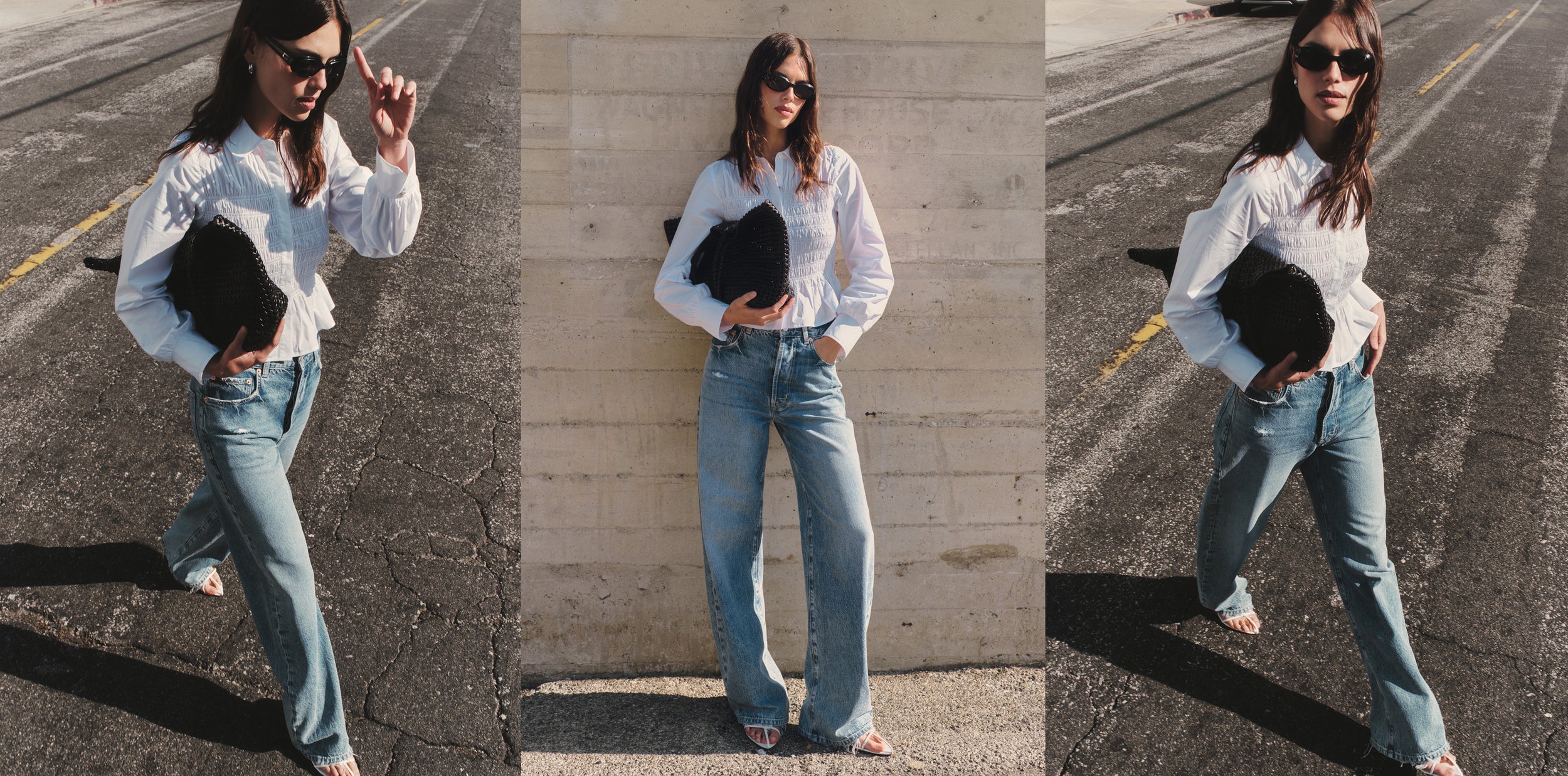 Woman wearing a white blouse and blue jeans while posing in the street