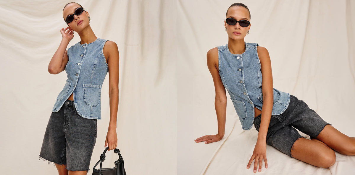A model is shown twice in a studio setting wearing a sleeveless light-wash denim vest with front pockets and dark denim shorts, styled with black sunglasses and a black handbag against a draped cream fabric backdrop.