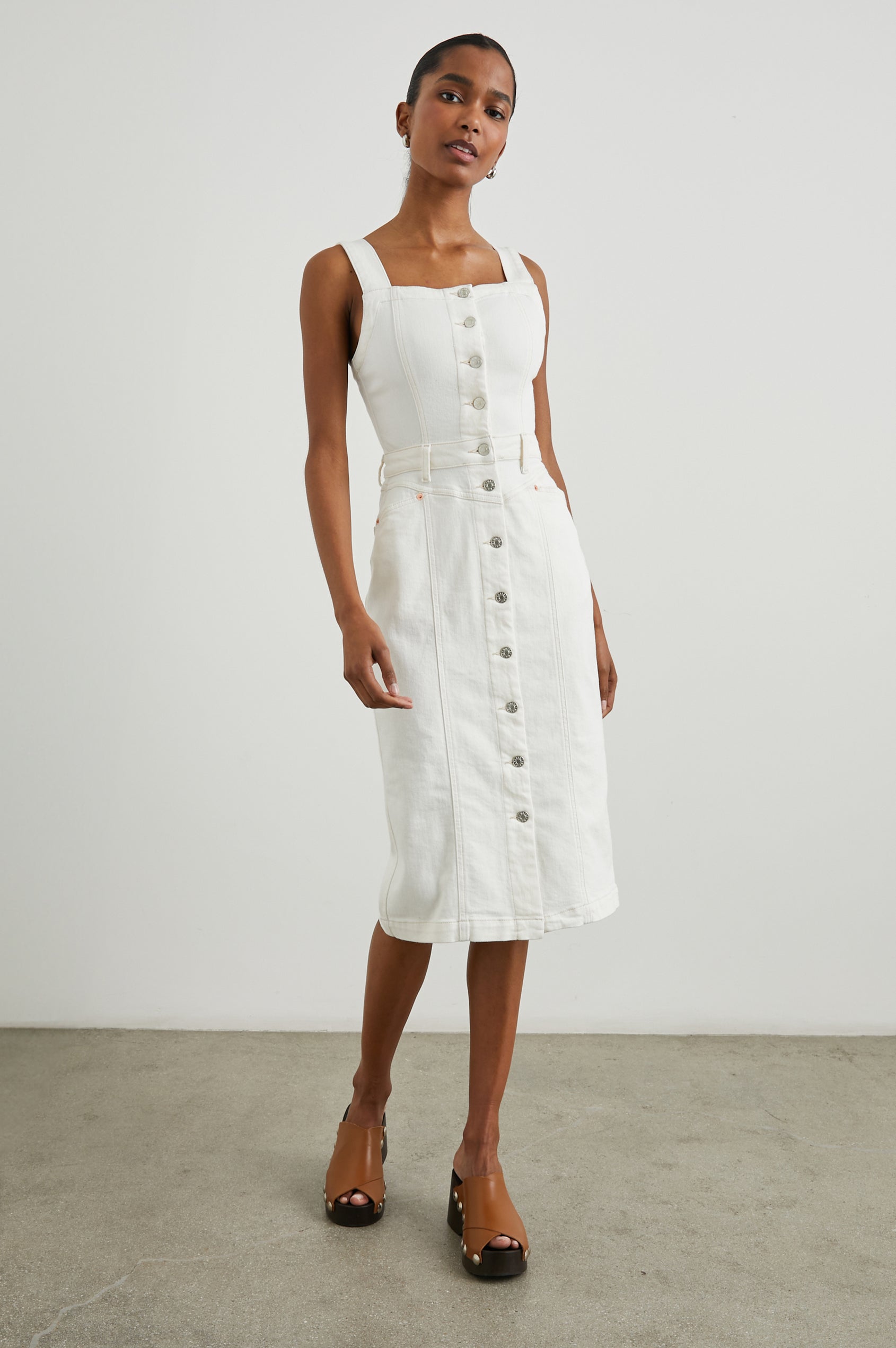 Malibu Sleeveless Denim Midi Dress with Shoulder Straps, Buttons Down the Front, a Square Neckline in the Front and Back, Two Front Pockets and Two Back Patch Pockets in Vintage Ecru Colorway - Front Full Body View Featured on Model