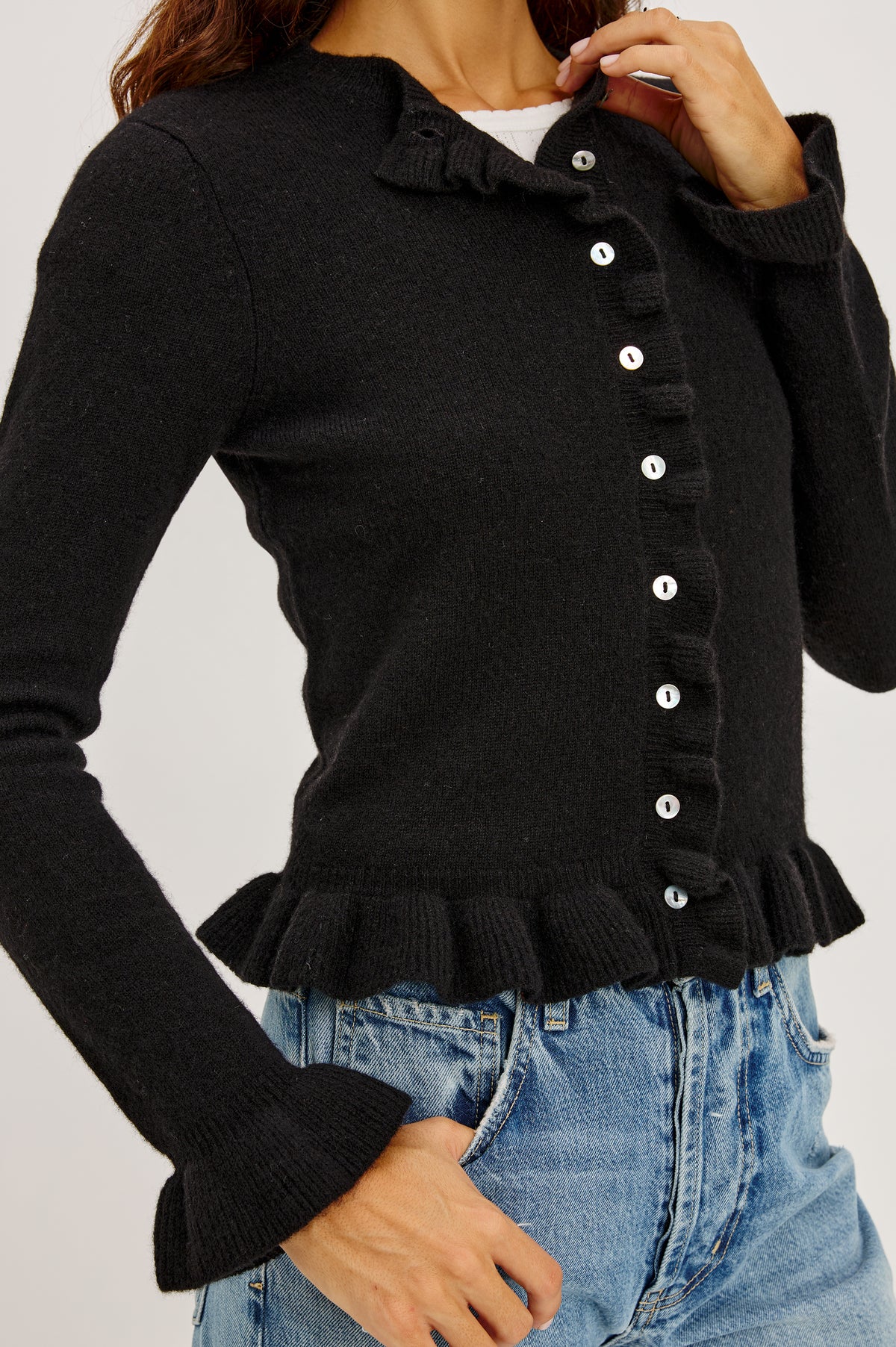 Mandy Sweater in Cashmere-Cotton-Wool Blend Knit Front Buttons, Long Sleeves, Classic Slightly Cropped Fit, and Ribbed Ruffle Trim in Black Colorway - Front Crop Detail View Featured on Model.