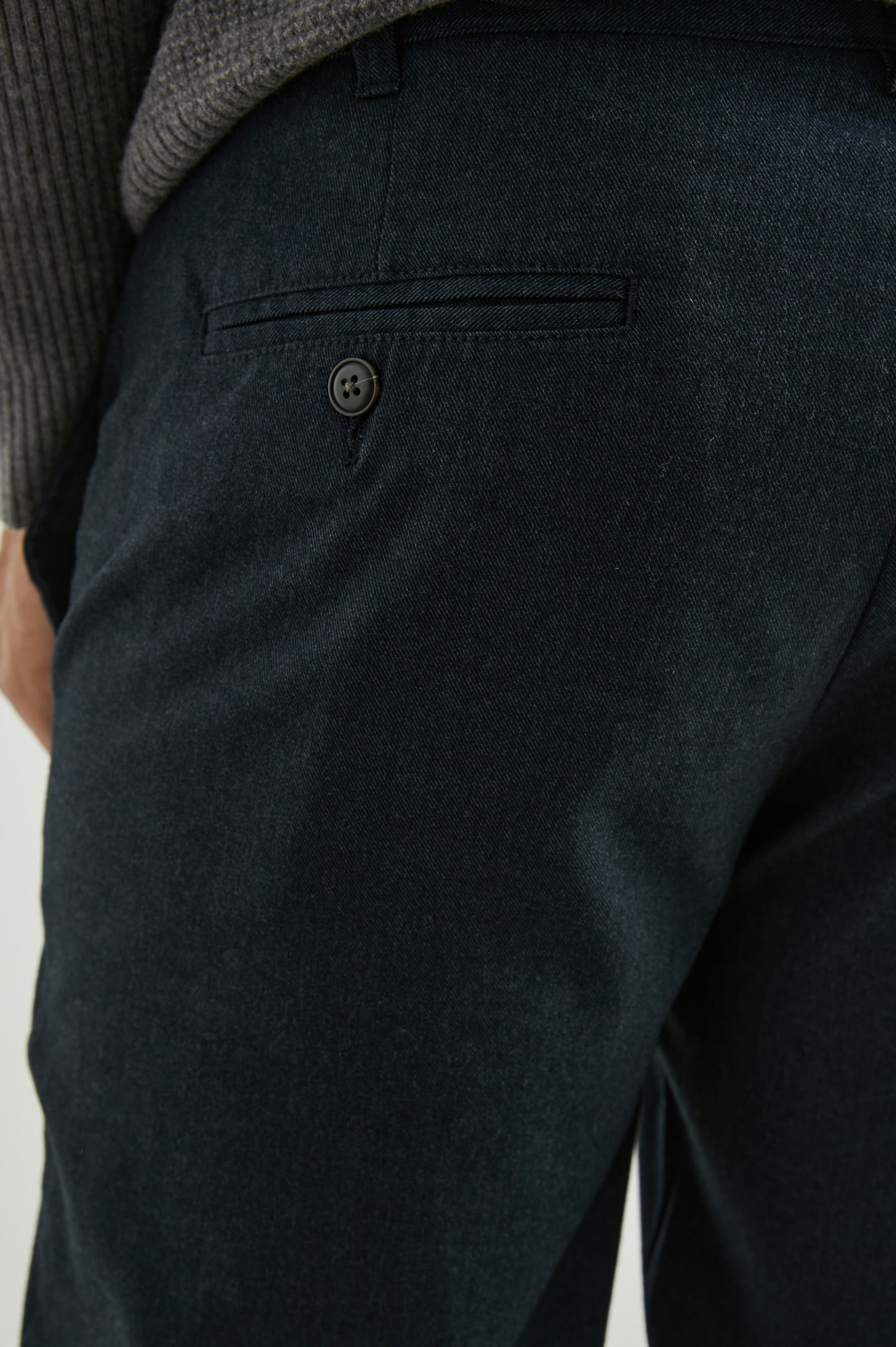 Marcellus Pants with Belt Loops, Two Seam Front Pockets, a Front Buttoned Flap Pocket, a Back Buttoned Welt Pocket and a Back Welt Pocket in Dark Navy Colorway - Back View Featured on Model 