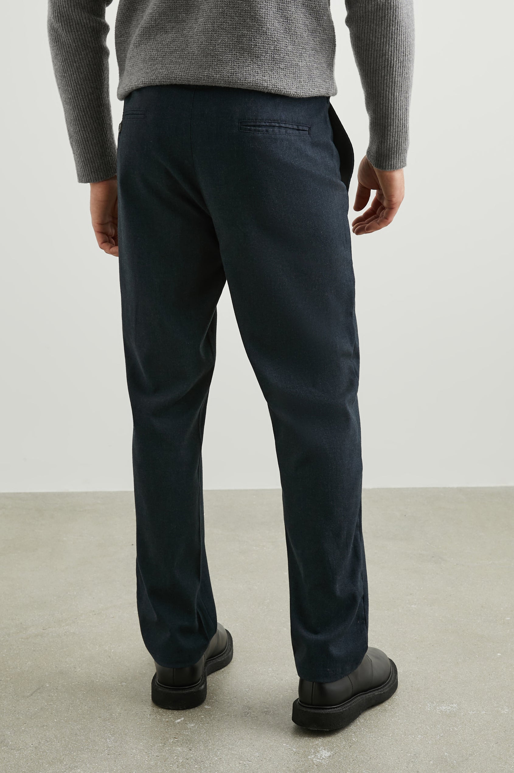Marcellus Pants with Belt Loops, Two Seam Front Pockets, a Front Buttoned Flap Pocket, a Back Buttoned Welt Pocket and a Back Welt Pocket in Dark Navy Colorway - Back View Featured on Model 