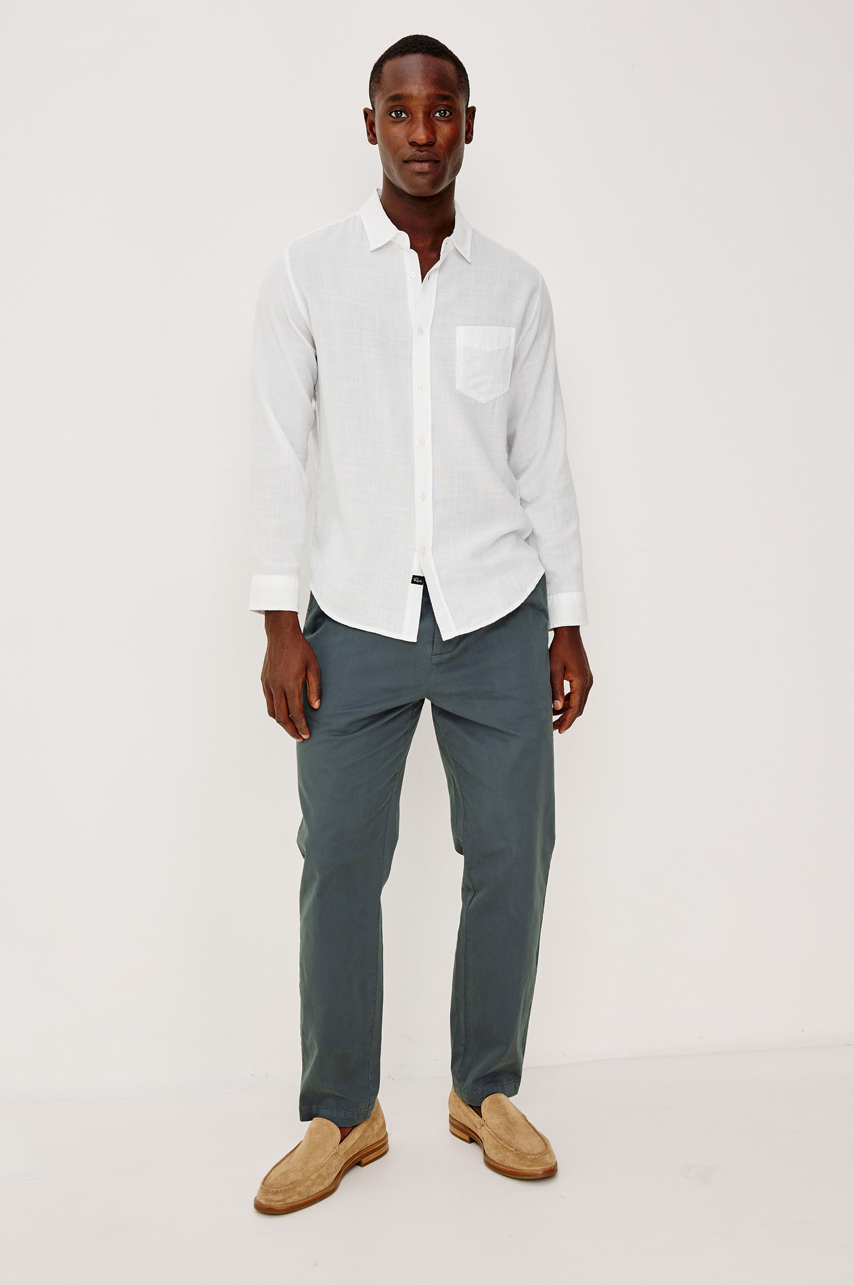 Marcellus Pants with Belt Loops, Two Seam Front Pockets, a Front Buttoned Flap Pocket, a Back Buttoned Welt Pocket and a Back Welt Pocket in Faded Blue Colorway - Front Full Body View Featured on Model