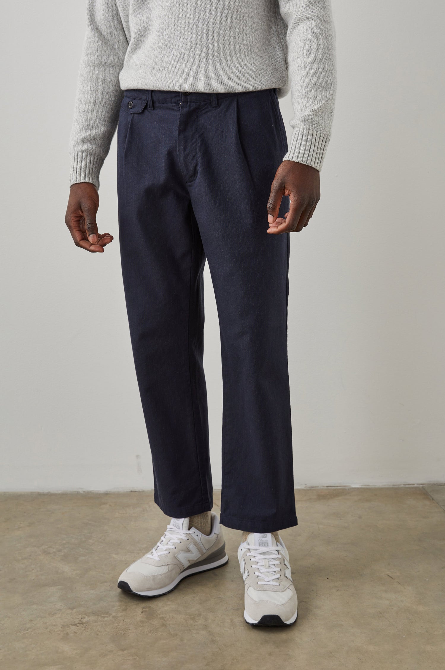 Marcellus Pants with Belt Loops, Two Seam Front Pockets, a Front Buttoned Flap Pocket, a Back Buttoned Welt Pocket and a Back Welt Pocket in Navy Charcoal Pin Stripe Colorway - Front View Featured on Model 