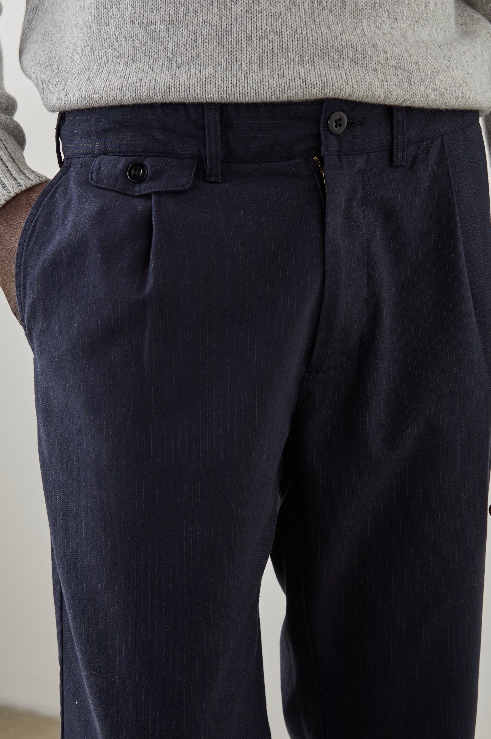 Marcellus Pants with Belt Loops, Two Seam Front Pockets, a Front Buttoned Flap Pocket, a Back Buttoned Welt Pocket and a Back Welt Pocket in Navy Charcoal Pin Stripe Colorway - Front View Featured on Model 