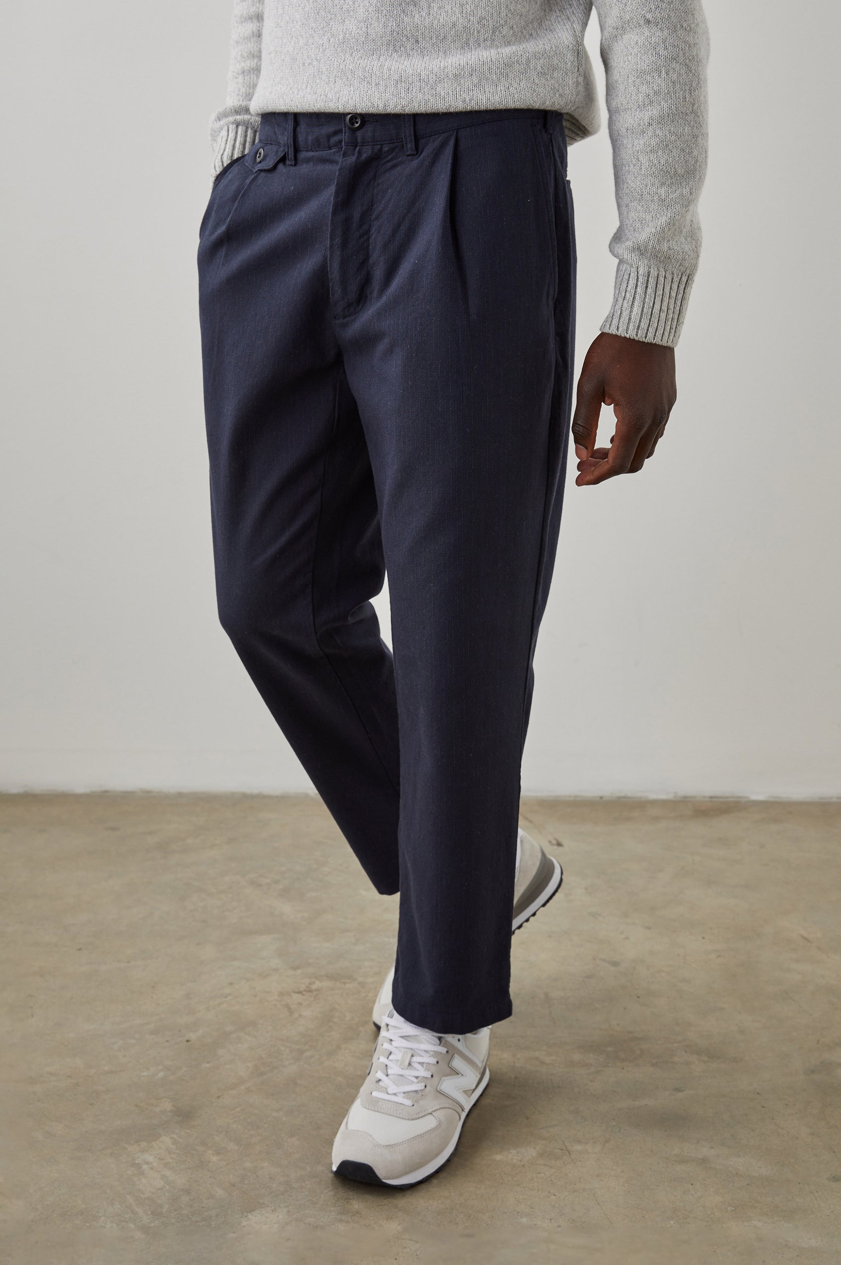 Marcellus Pants with Belt Loops, Two Seam Front Pockets, a Front Buttoned Flap Pocket, a Back Buttoned Welt Pocket and a Back Welt Pocket in Navy Charcoal Pin Stripe Colorway - Front View Featured on Model 