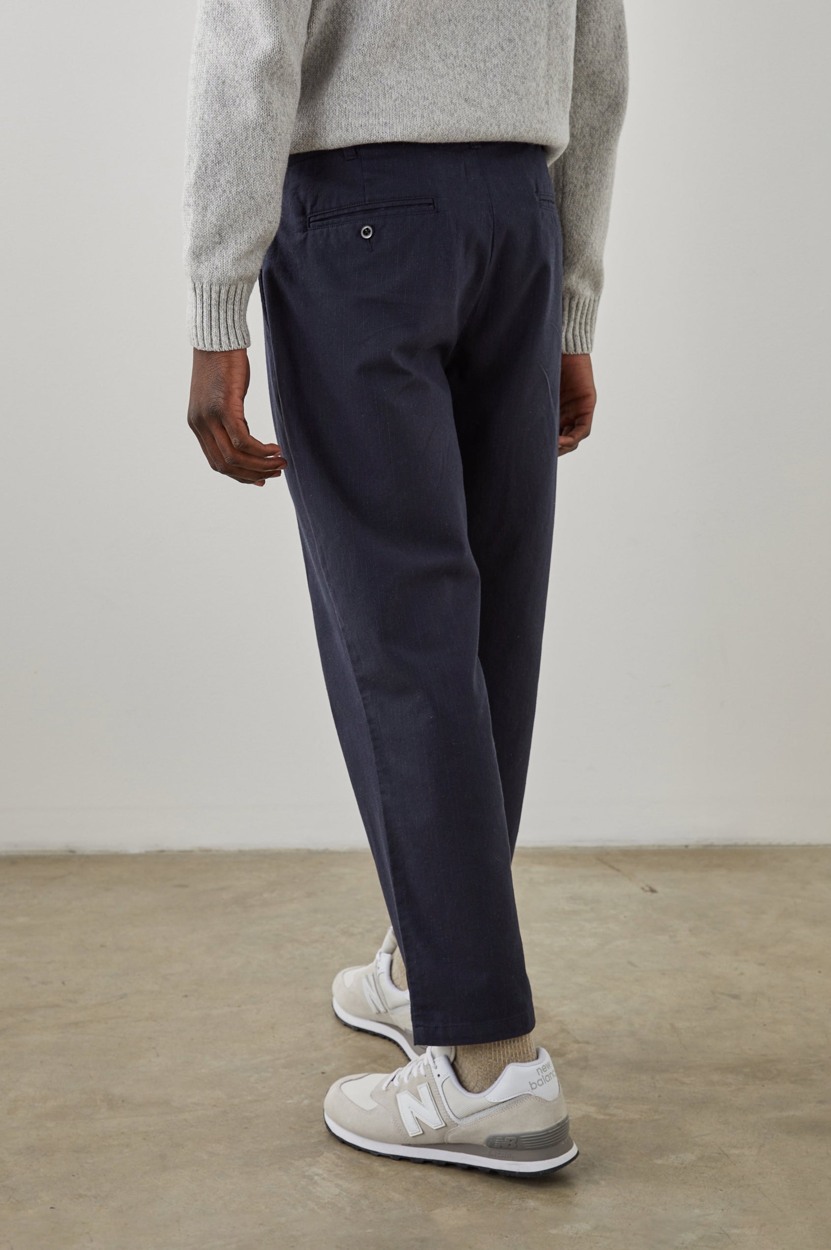 Marcellus Pants with Belt Loops, Two Seam Front Pockets, a Front Buttoned Flap Pocket, a Back Buttoned Welt Pocket and a Back Welt Pocket in Navy Charcoal Pin Stripe Colorway - Back View Featured on Model 