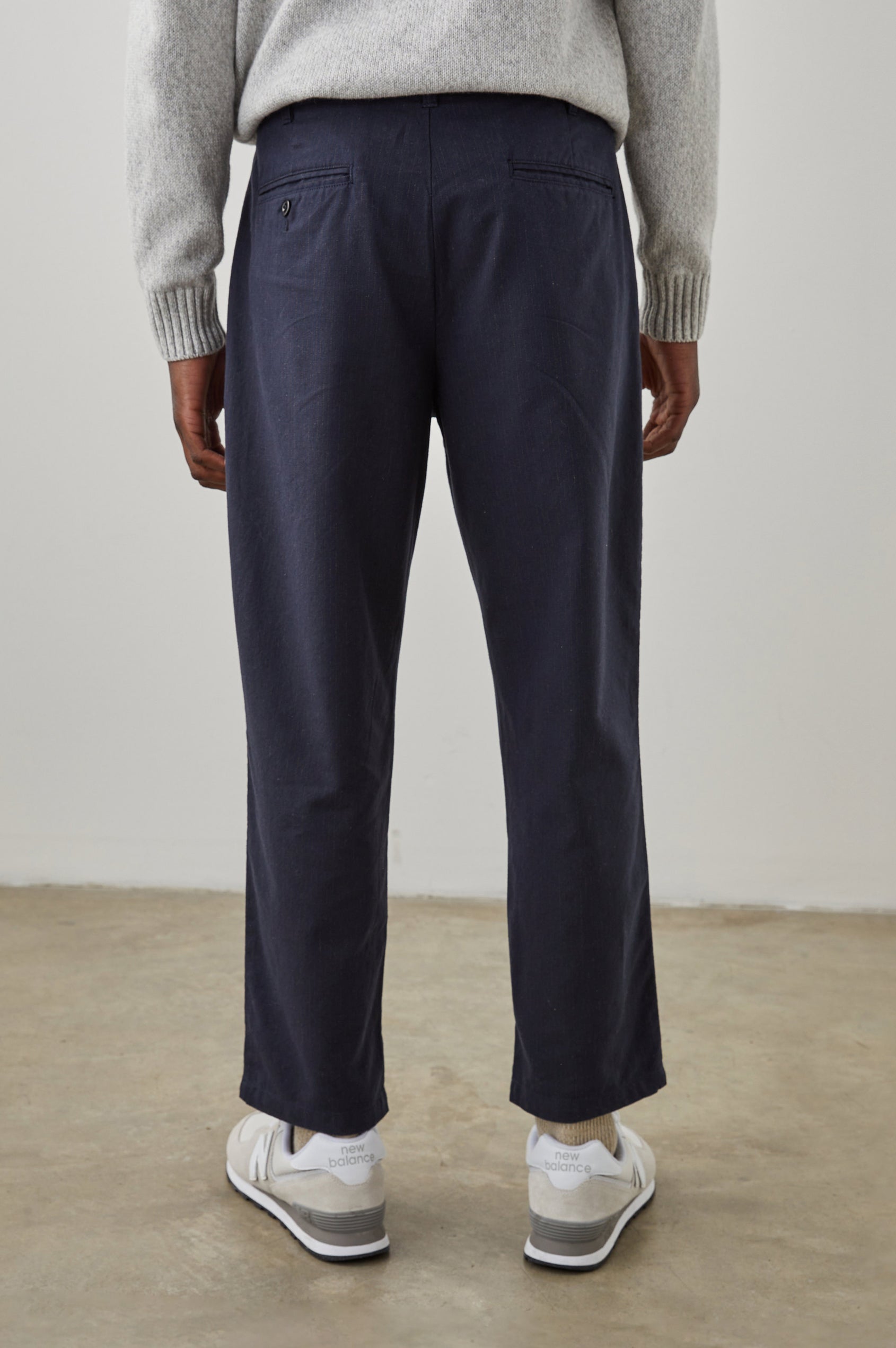 Marcellus Pants with Belt Loops, Two Seam Front Pockets, a Front Buttoned Flap Pocket, a Back Buttoned Welt Pocket and a Back Welt Pocket in Navy Charcoal Pin Stripe Colorway - Back View Featured on Model 