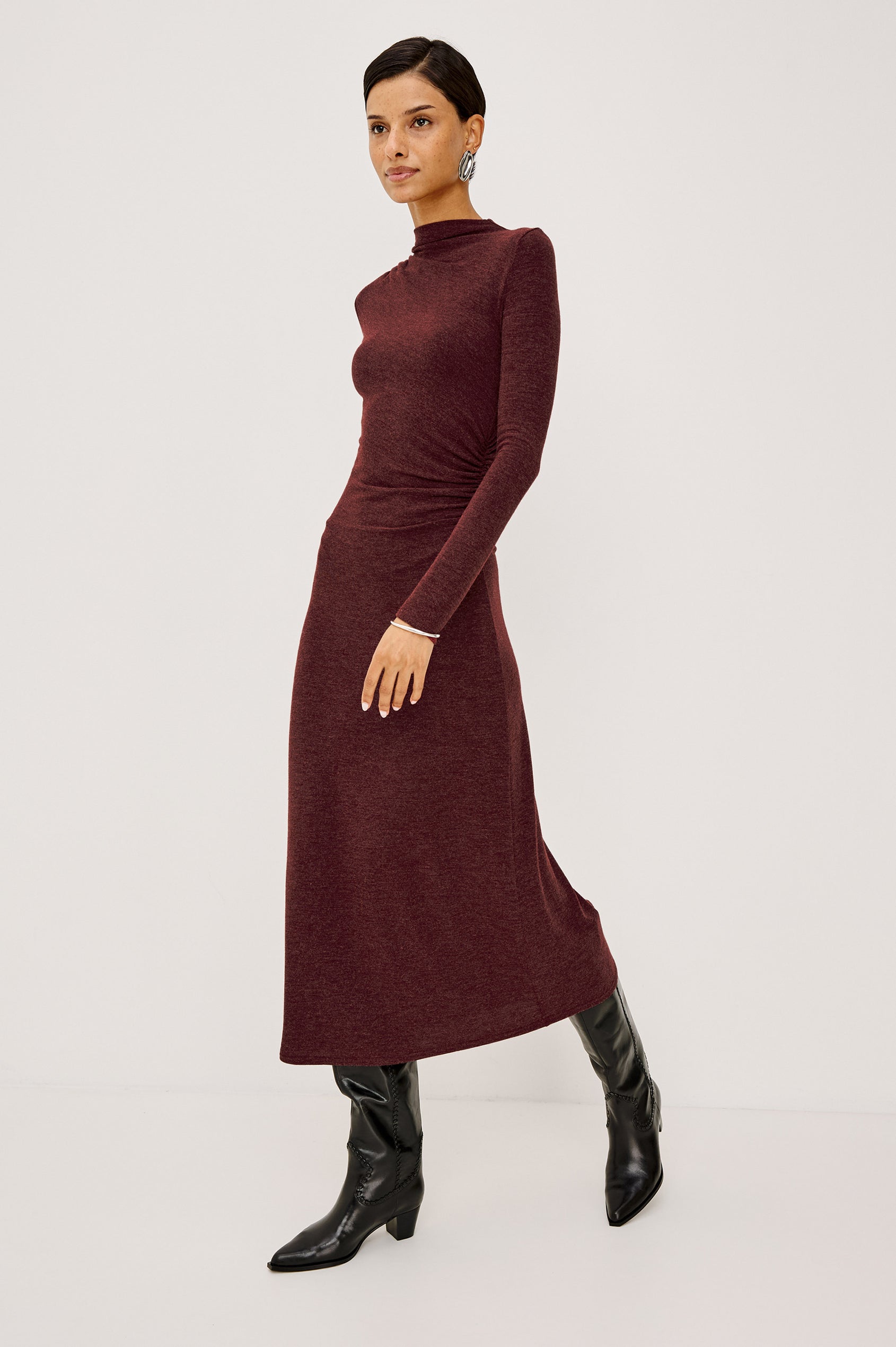 Margaret Midi Dress in Brushed Tissue Jersey With Mock Neck, Long Sleeves, Ruched Sides, and Fitted Silhouette in Merlot Colorway - Full Body Side View Featured on Model