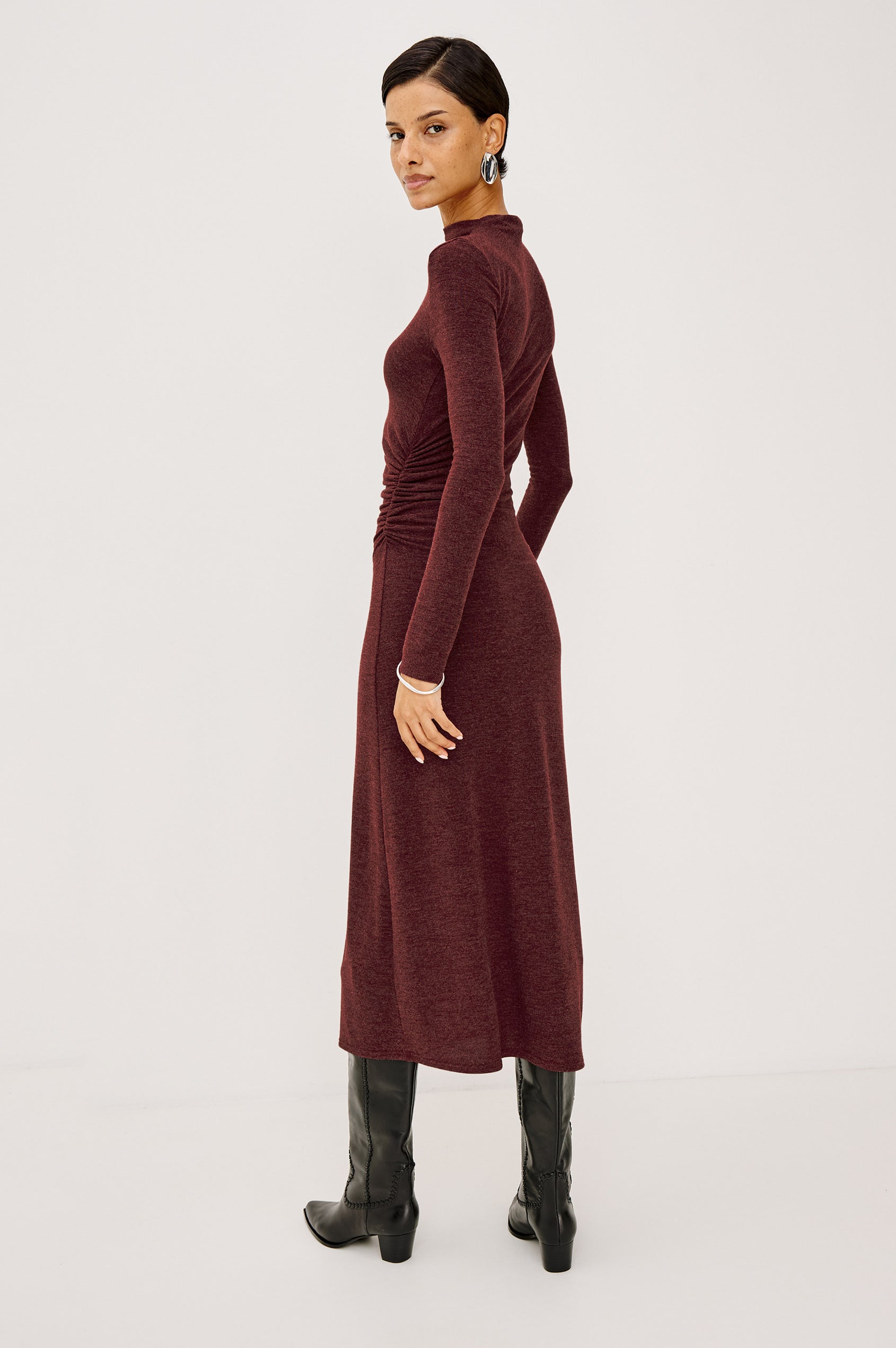 Margaret Midi Dress in Brushed Tissue Jersey With Mock Neck, Long Sleeves, Ruched Sides, and Fitted Silhouette in Merlot Colorway - Full Body Side View Featured on Model