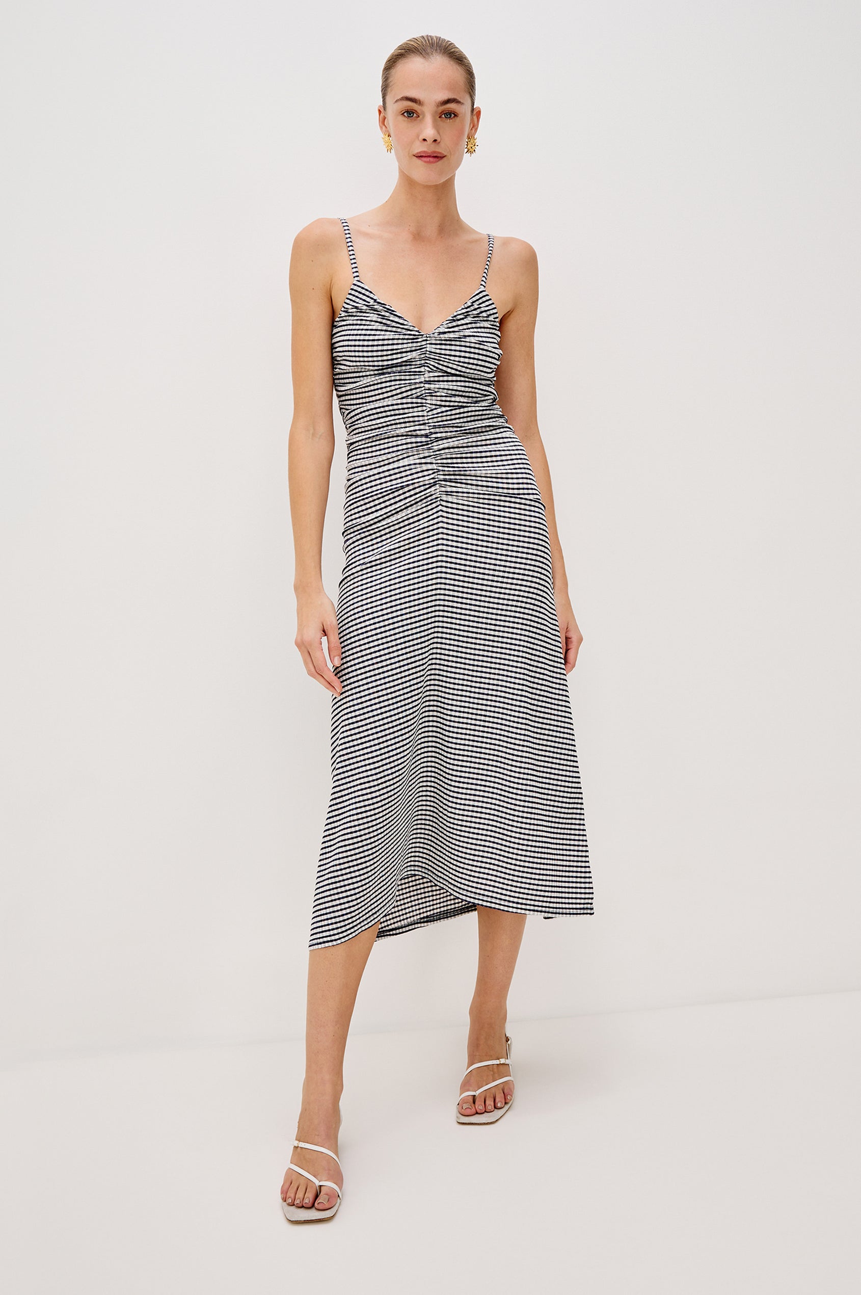 Mari Midi Dress with Spaghetti Straps, V-Front, A-Line Silhouette and Gathering Down Center Front in Navy Gingham Colorway. Full Body Front View Shown on Model.