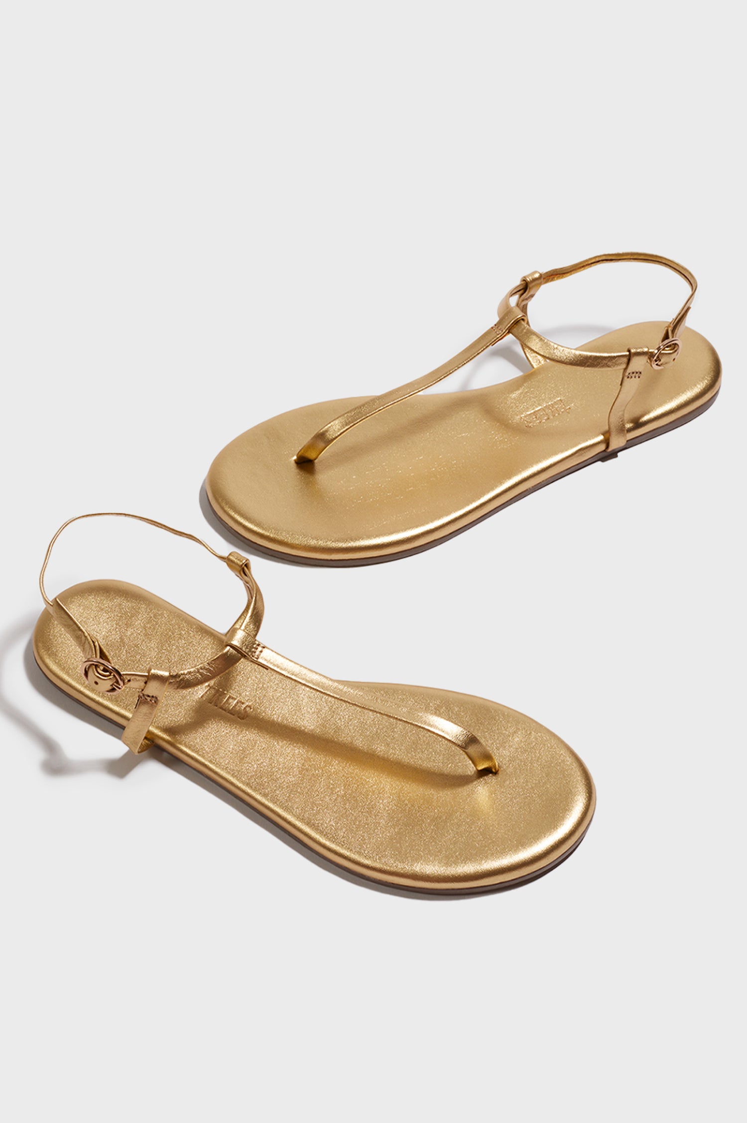 Mariana leather t-strap sandal with ankle strap and buckle in metallic Blink - cross angled view of pair of shoes