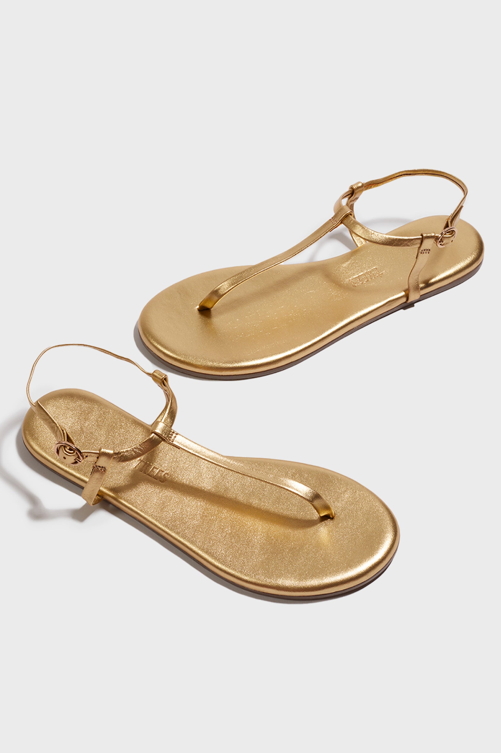 Mariana leather t-strap sandal with ankle strap and buckle in metallic Blink - cross angled view of pair of shoes