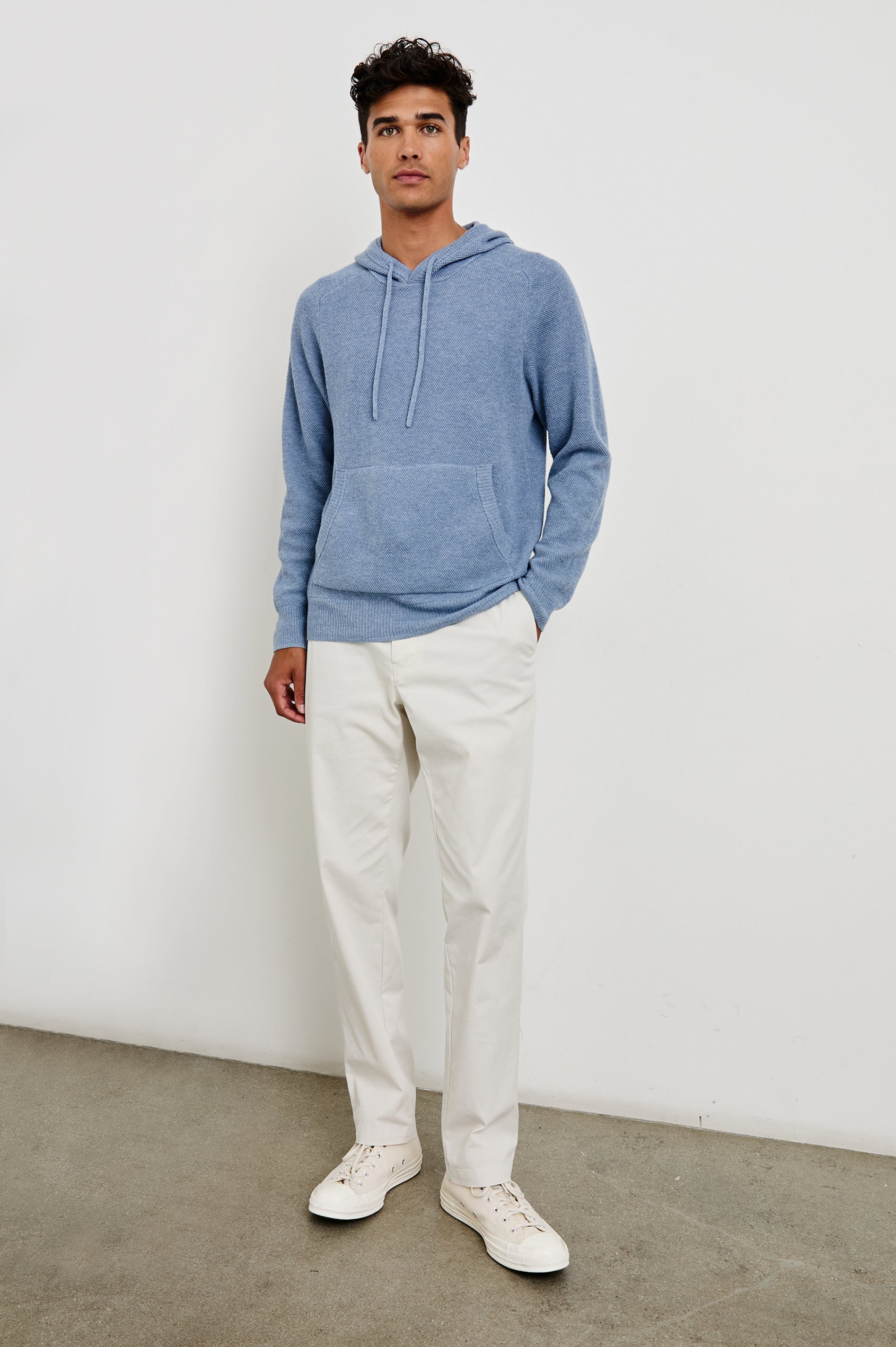 Matador knit sweater with hoodie, adjustable drawstrings, and dual side front pocket in Light Blue Heather - full body front view on model