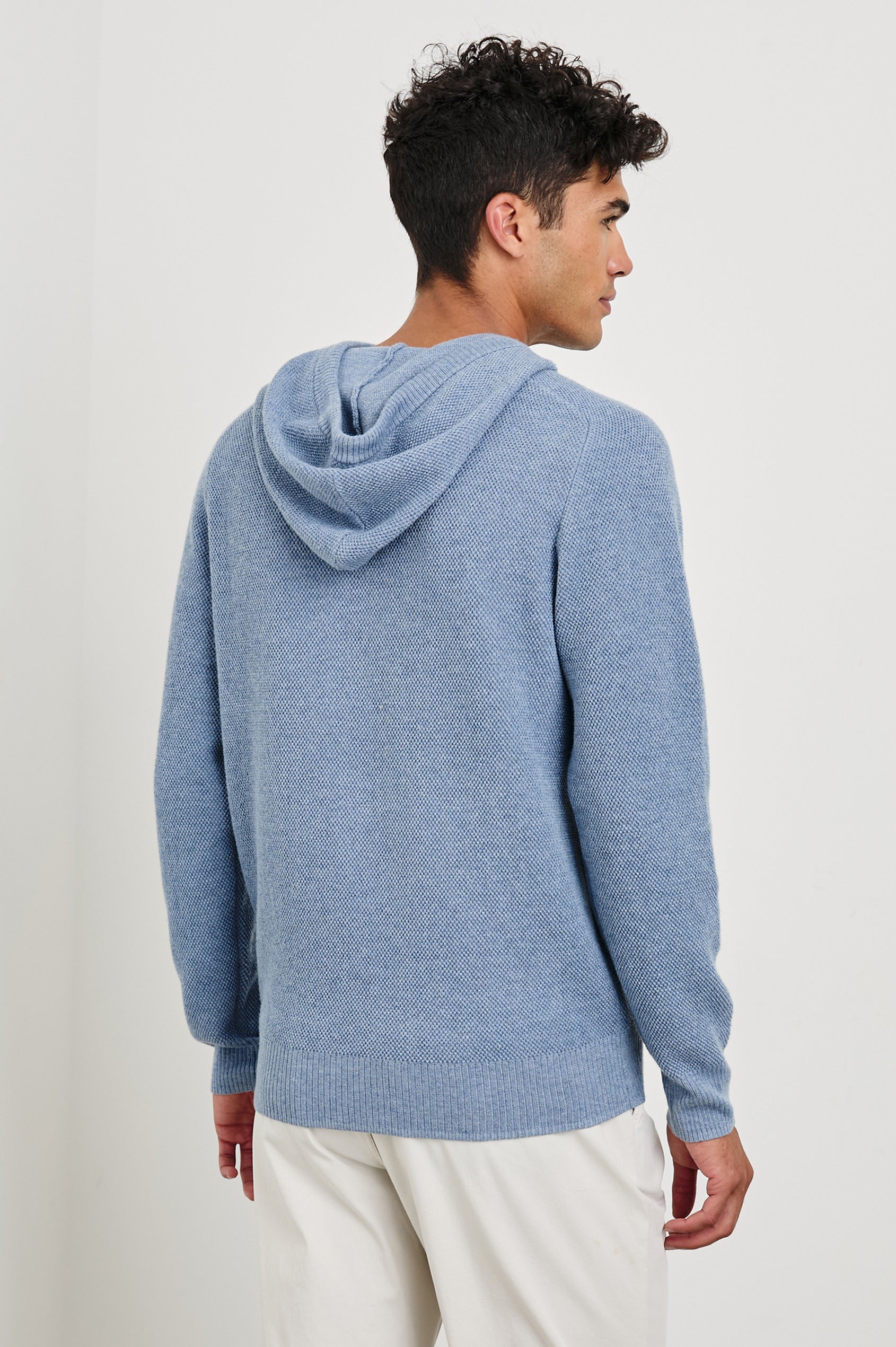 Matador knit sweater with hoodie, adjustable drawstrings, and dual side front pocket in Light Blue Heather -back view on model