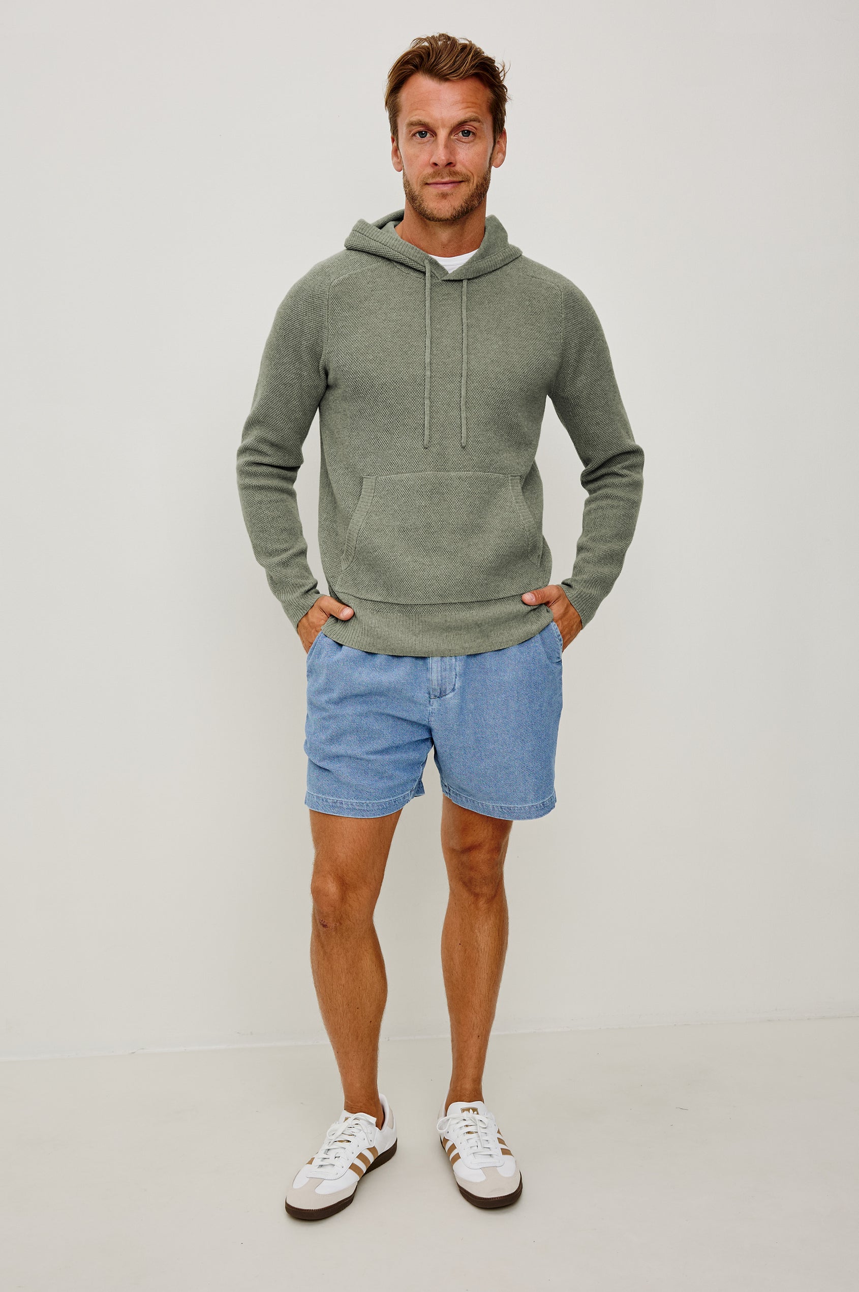 Matador Hoodie Sweatshirt in Cotton Blend With Drawstring TIes, Front Kangaroo Pockets, and Long Sleeves in Sage Heather - Full Body Front View Featured on Model