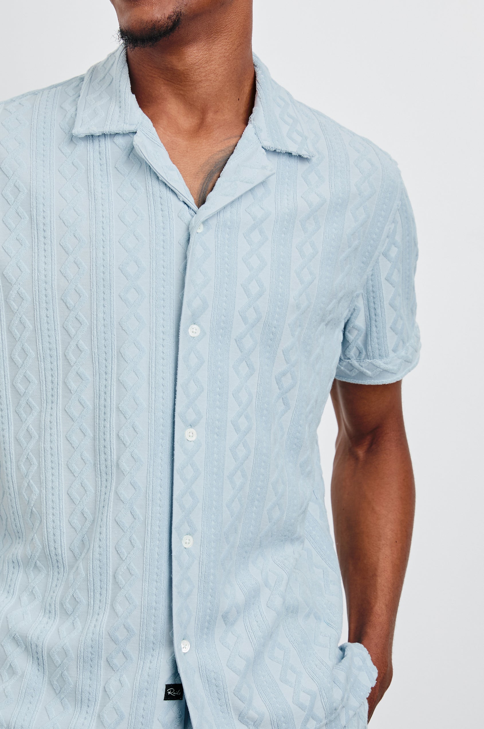 Maverick Short Sleeve Button Up with a raised jacquard pattern in Coastal Blue Colorway - Front View Featured on Model