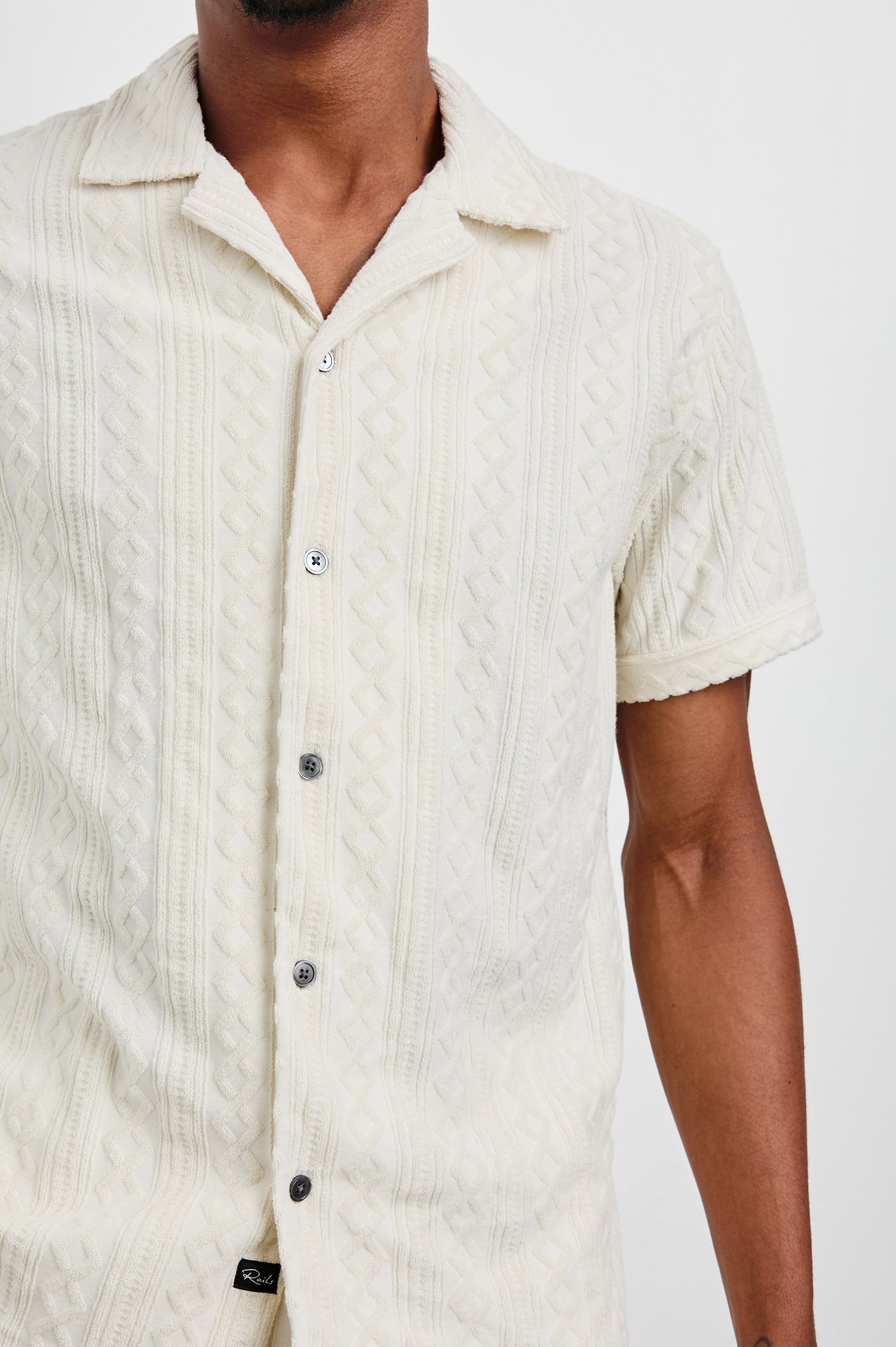 Maverick Short Sleeve Button Up with a raised jacquard pattern in Ecru Colorway - Front View Featured on Model