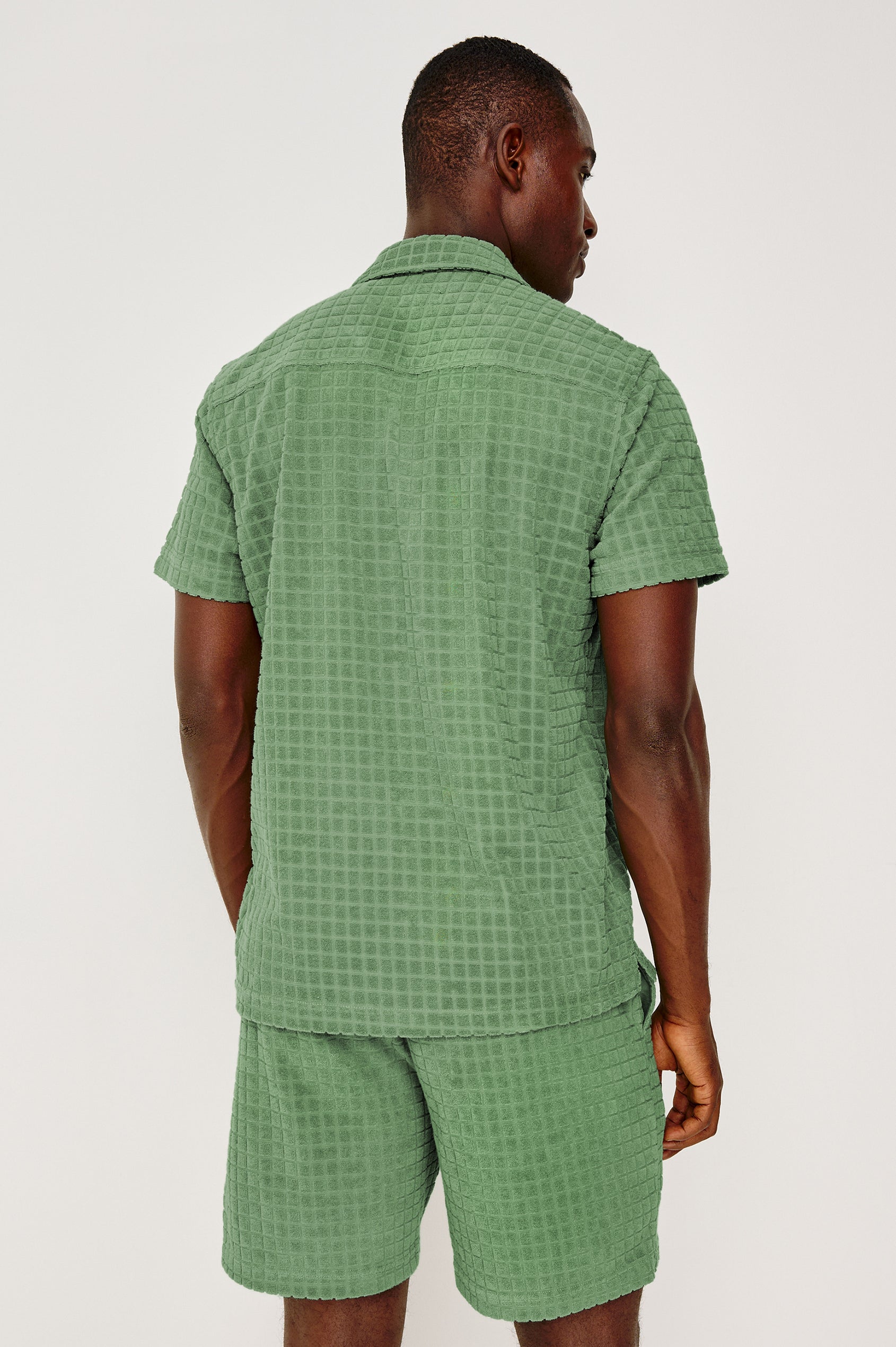 Maverick Short Sleeve Shirt in French Terry With Jacquard Pattern, Notched Collar, Front Buttons, and Classic Fit in Green Bay Grid Colorway - Upper Body Back View Featured on Model