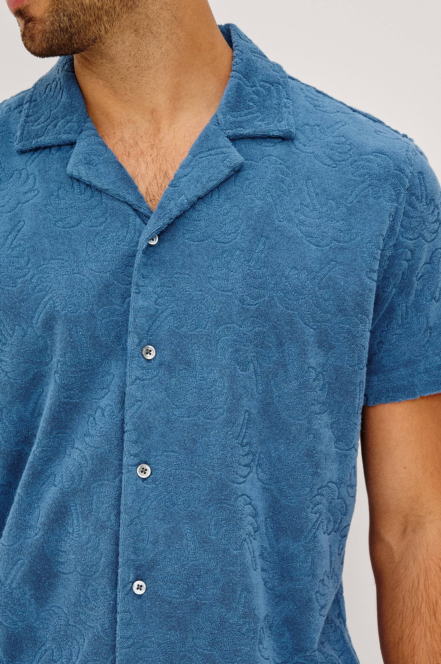 Maverick Short Sleeve Shirt in French Terry With Jacquard Pattern, Notched Collar, Front Buttons, and Classic Fit in Royal Palm Colorway - Upper Body Front View Featured on Model