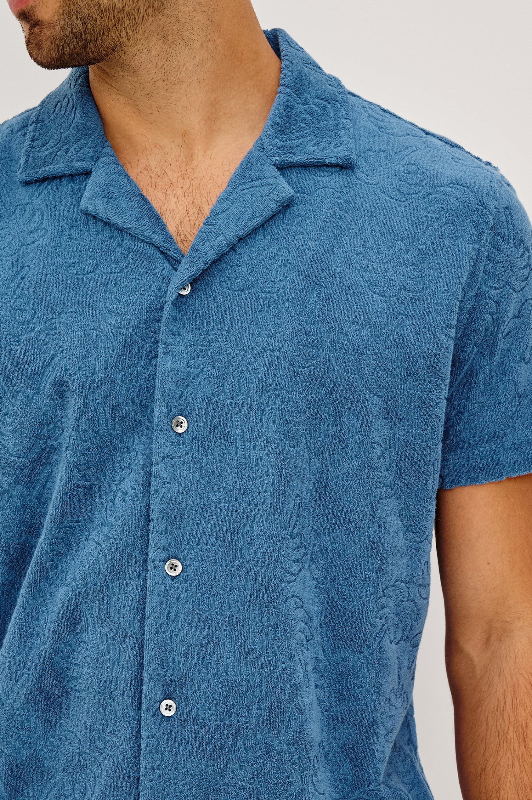 Maverick Short Sleeve Shirt in French Terry With Jacquard Pattern, Notched Collar, Front Buttons, and Classic Fit in Royal Palm Colorway - Upper Body Front View Featured on Model