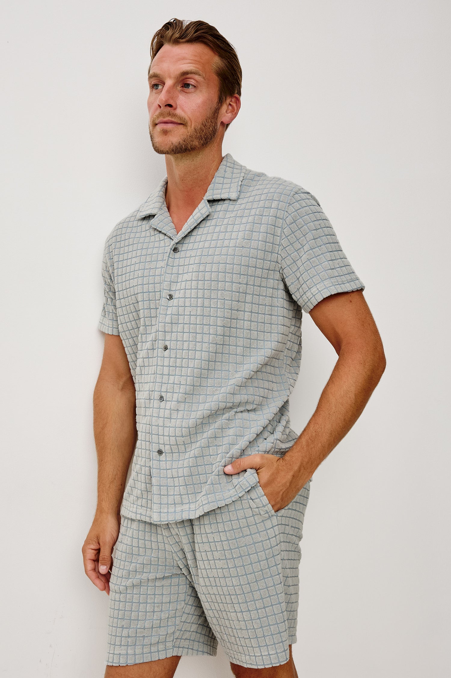 Maverick Short Sleeve Shirt in French Terry With Jacquard Pattern, Notched Collar, Front Buttons, and Classic Fit in Silver Line Blue Grid Colorway - Upper Body Front View Featured on Model