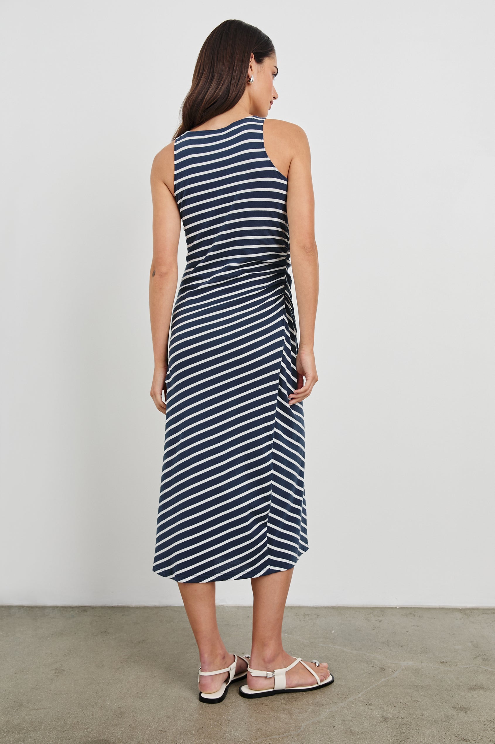 Max Wrap Dress with a Scoop Neck, Sleeveless, Gathering at Side Seam and Front Slit in Navy and White Nautical Stripe Colorway. Back View Shown on Model.