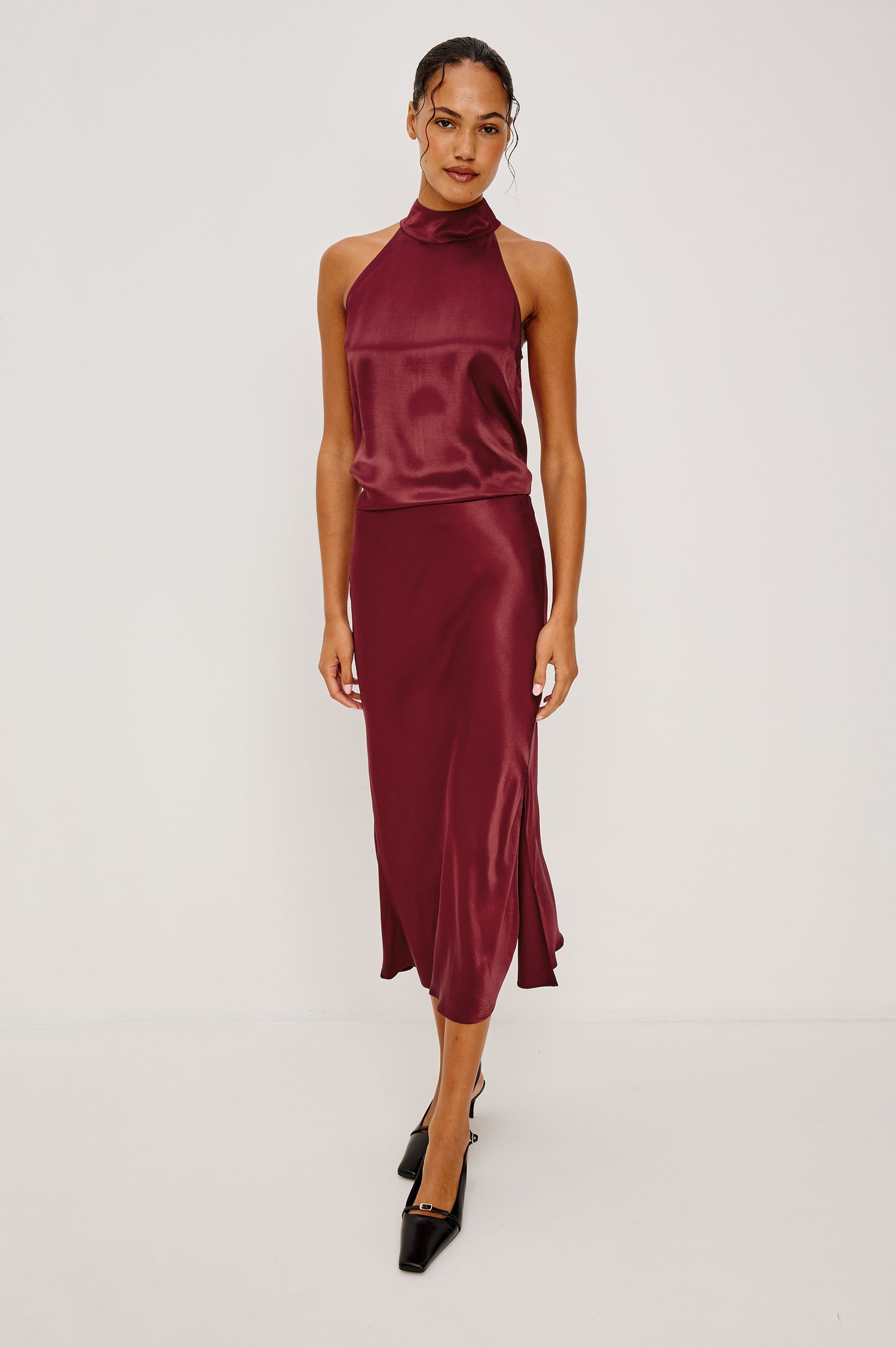 Maya Midi Skirt in Satin Back Crepe With Mid-Thigh Side Slit in Garnet Colorway - Full Body Front View Featured on Model