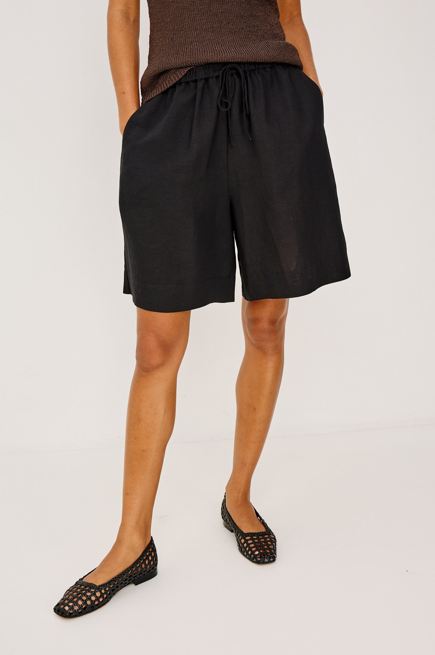 McGuire Mid-Rise Short in Linen Viscose With Bermuda Length, Elastic Waist With Drawcords, Pockets, and Loose Relaxed Fit in White Colorway - Lower Body Front View Featured on Model