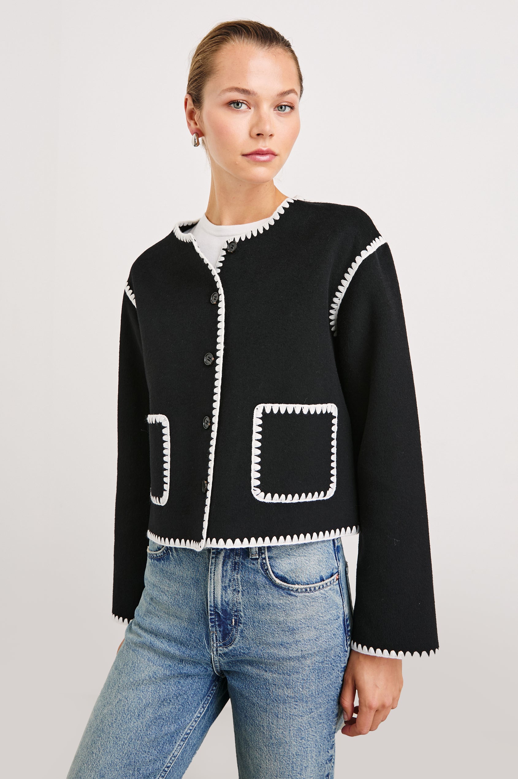 Melanie Jacket with Button Closure and Two Front Patch Pockets in Black Colorway, with White Stitching along the Trim and Pockets - Front View Featured on Model