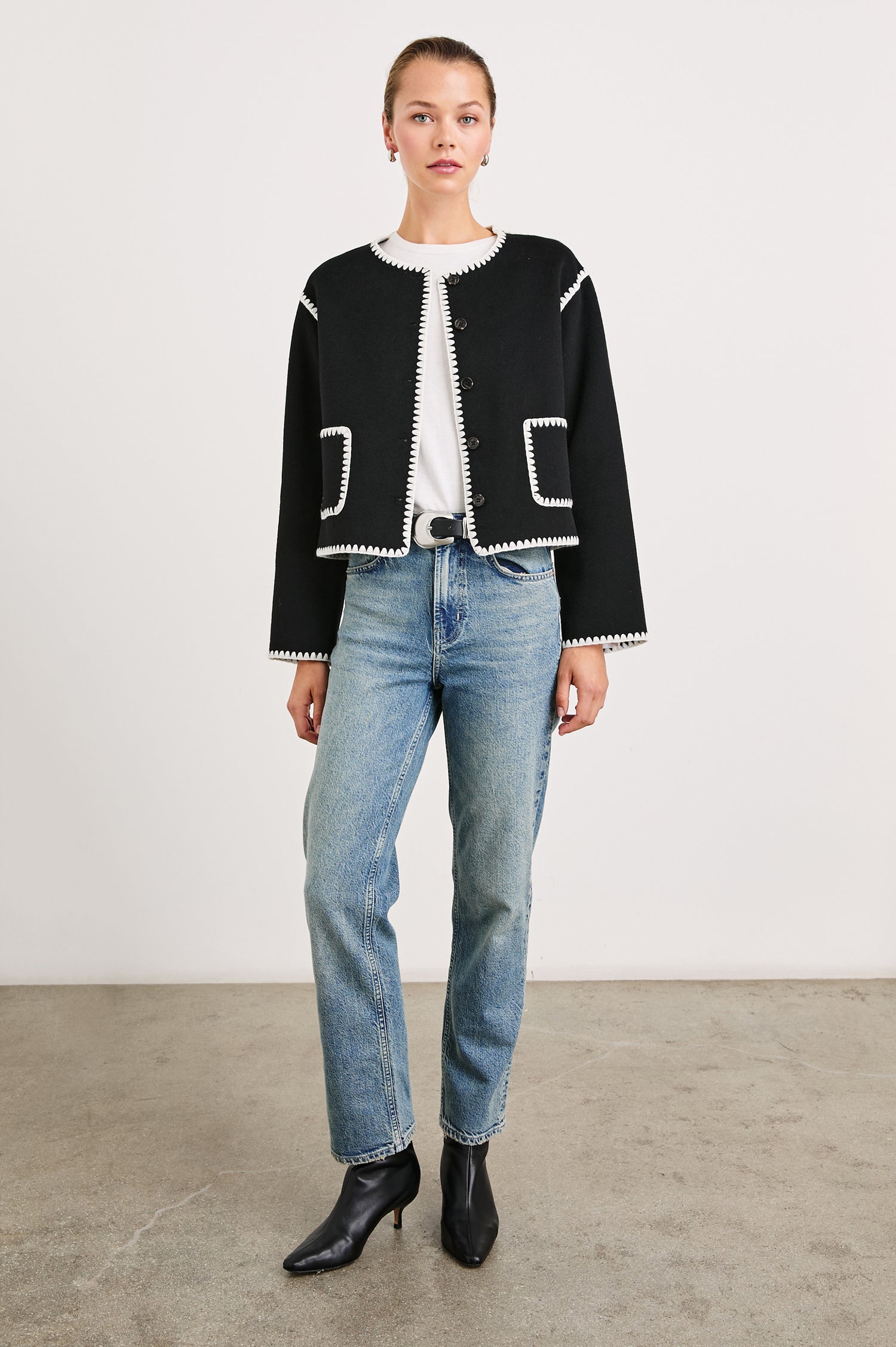 Melanie Jacket with Button Closure and Two Front Patch Pockets in Black Colorway, with White Stitching along the Trim and Pockets - Front Full Body View Featured on Model