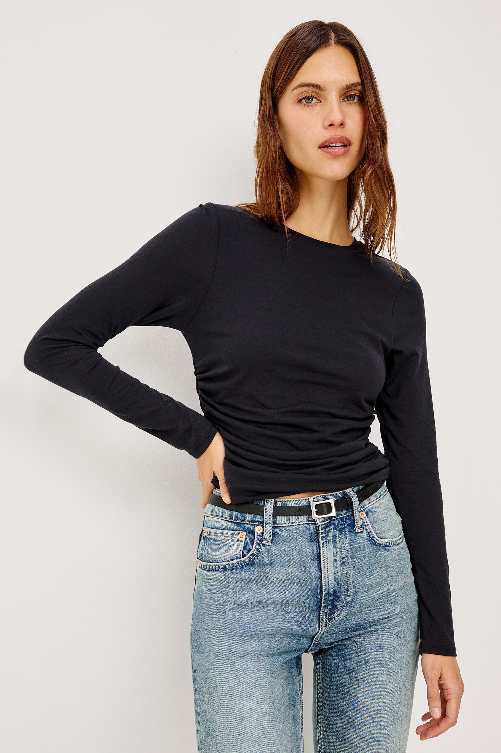 Melle Fitted Top in Organic Cotton With Crew Neckline, Side Shirring, and Long Sleeves in Black Colorway - Upper Body Front View Featured on Model