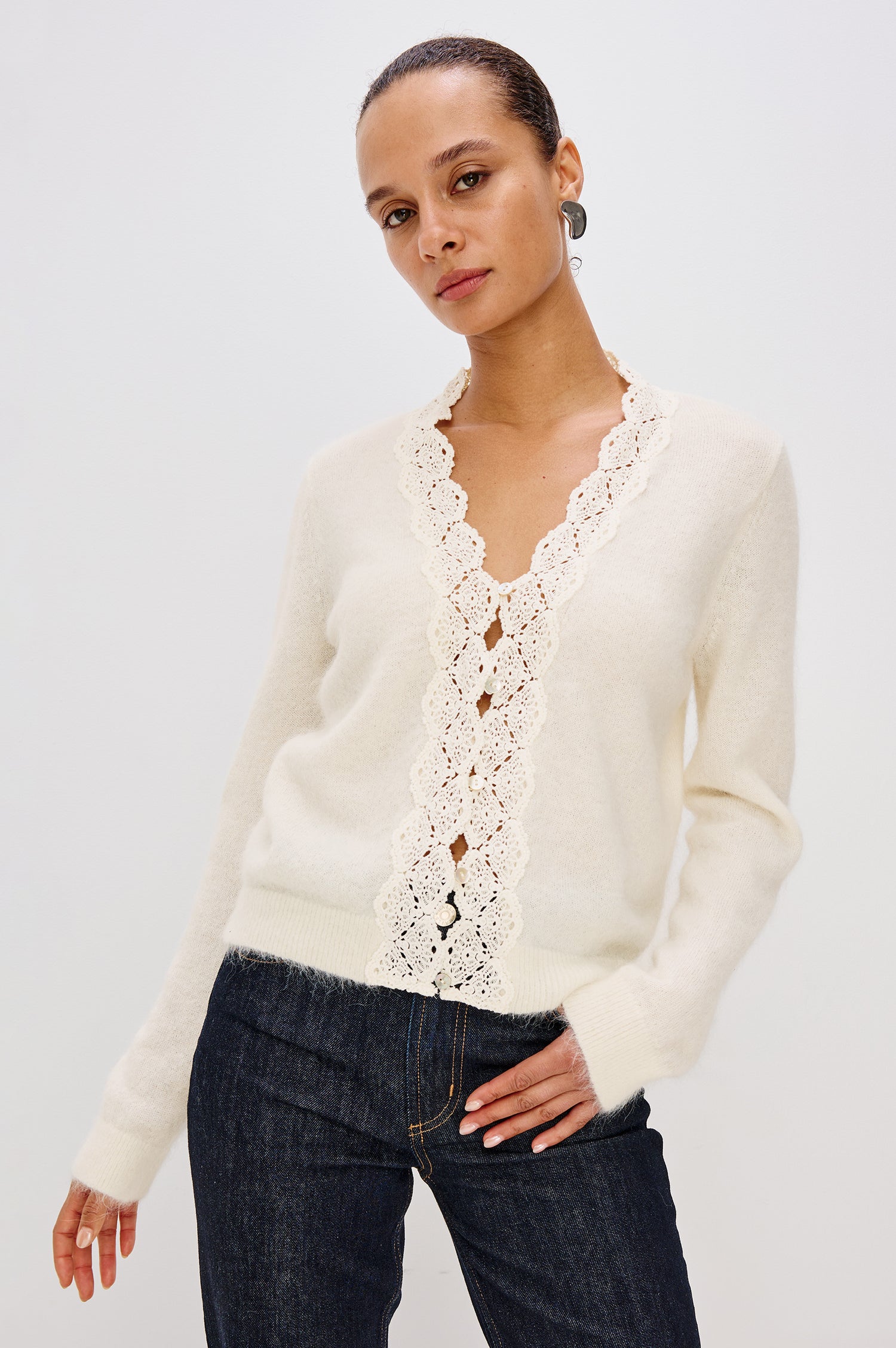 Knitted from a soft alpaca-wool blend, the Mer features a flattering V-neckline trimmed with delicate lace extending to the hem. With front button closures and long sleeves. Front Crop View featured on Model.