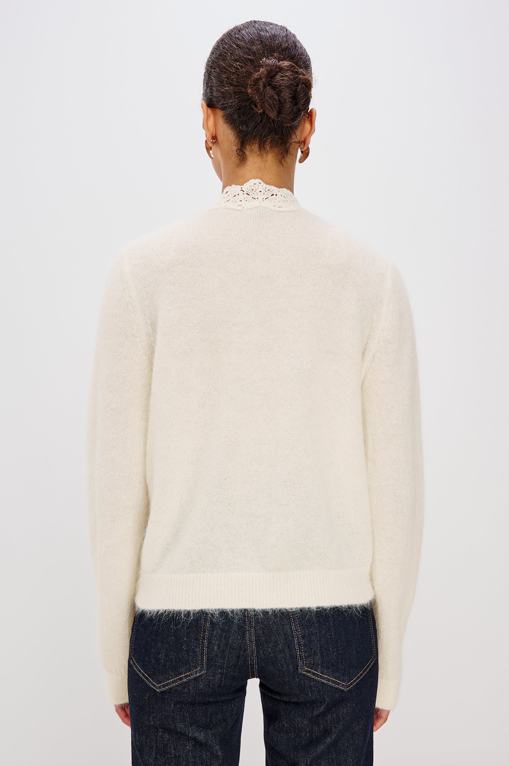 Knitted from a soft alpaca-wool blend, the Mer features a flattering V-neckline trimmed with delicate lace extending to the hem. With front button closures and long sleeves. Back View featured on Model.