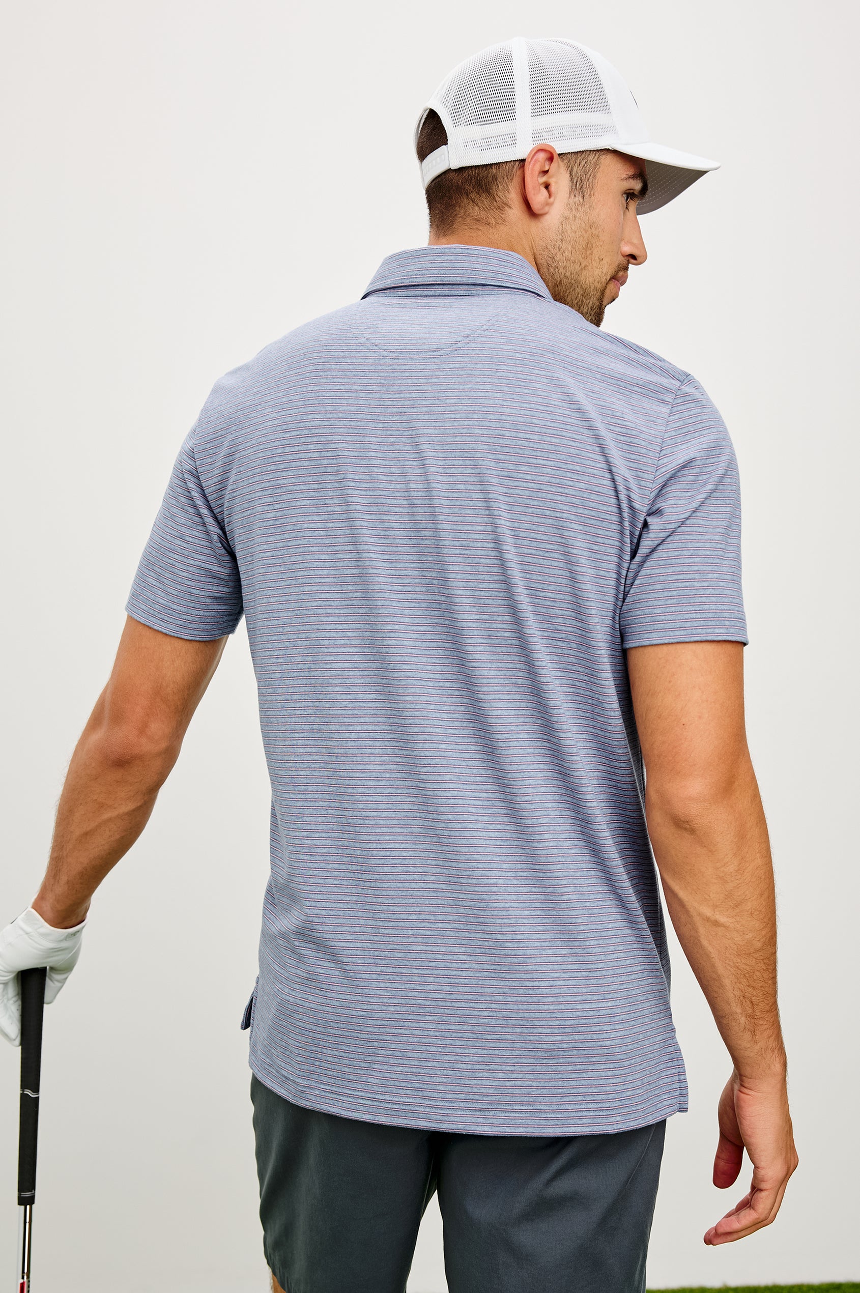 Merced Golf Polo in TENCEL™ Poly Blend With Collar, Quarter Placket, Short Sleeves, and Classic Fit in Hibiscus Mirage Stripe Colorway - Upper Body Back View Featured on Model
