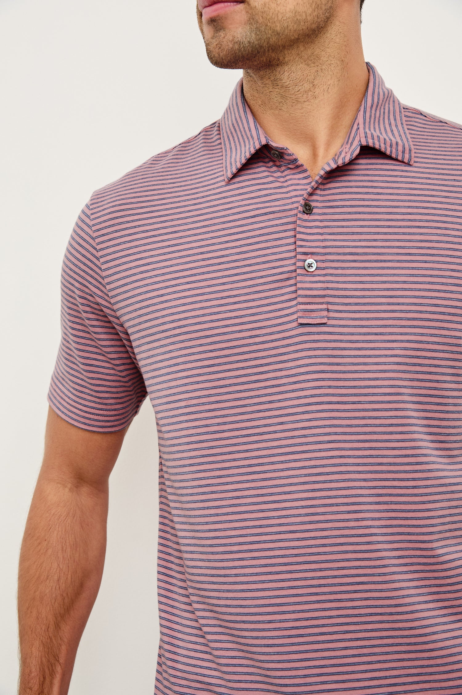 Merced short sleeve athletic Golf Polo with two button placket and collar in Hibiscus Mirage Stripe - close up of details on model