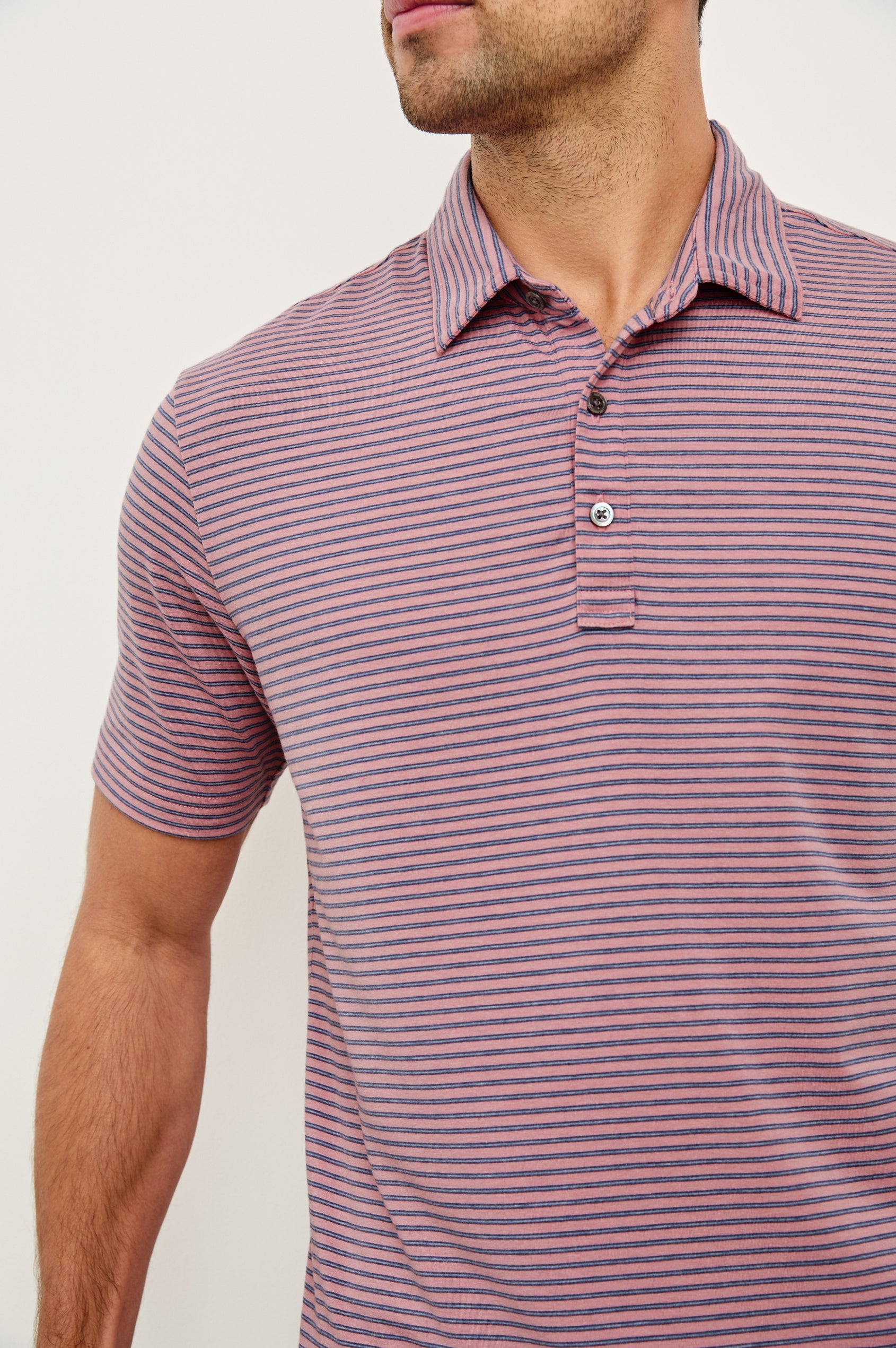 Merced short sleeve athletic Golf Polo with two button placket and collar in Hibiscus Mirage Stripe - close up of details on model