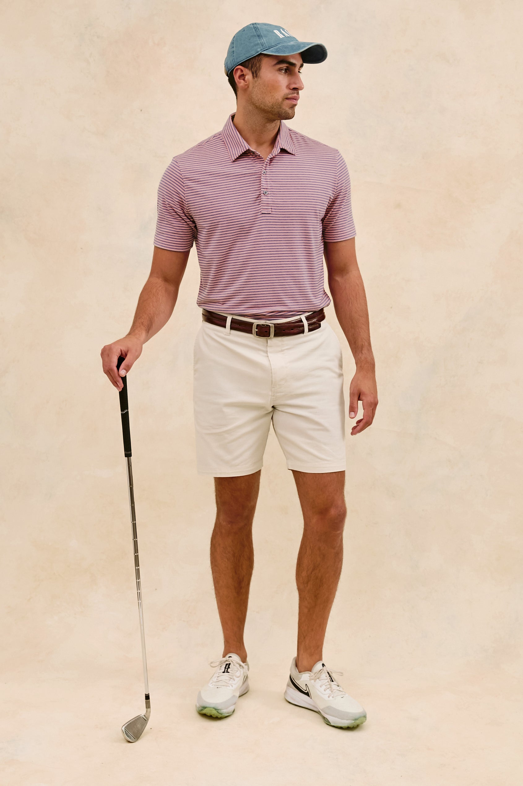 Merced short sleeve athletic Golf Polo with two button placket and collar in Hibiscus Mirage Stripe - full body front view on model