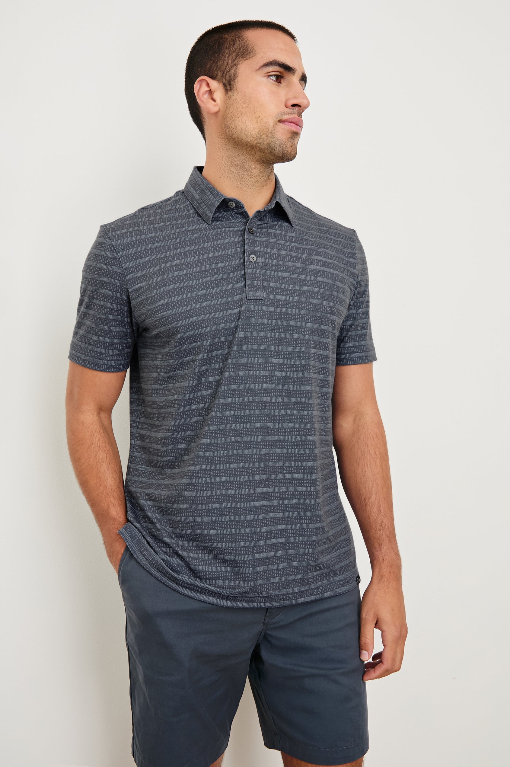 Merced short sleeve athletic Golf Polo with two button placket and collar in Sashiko Border Black - front view on model