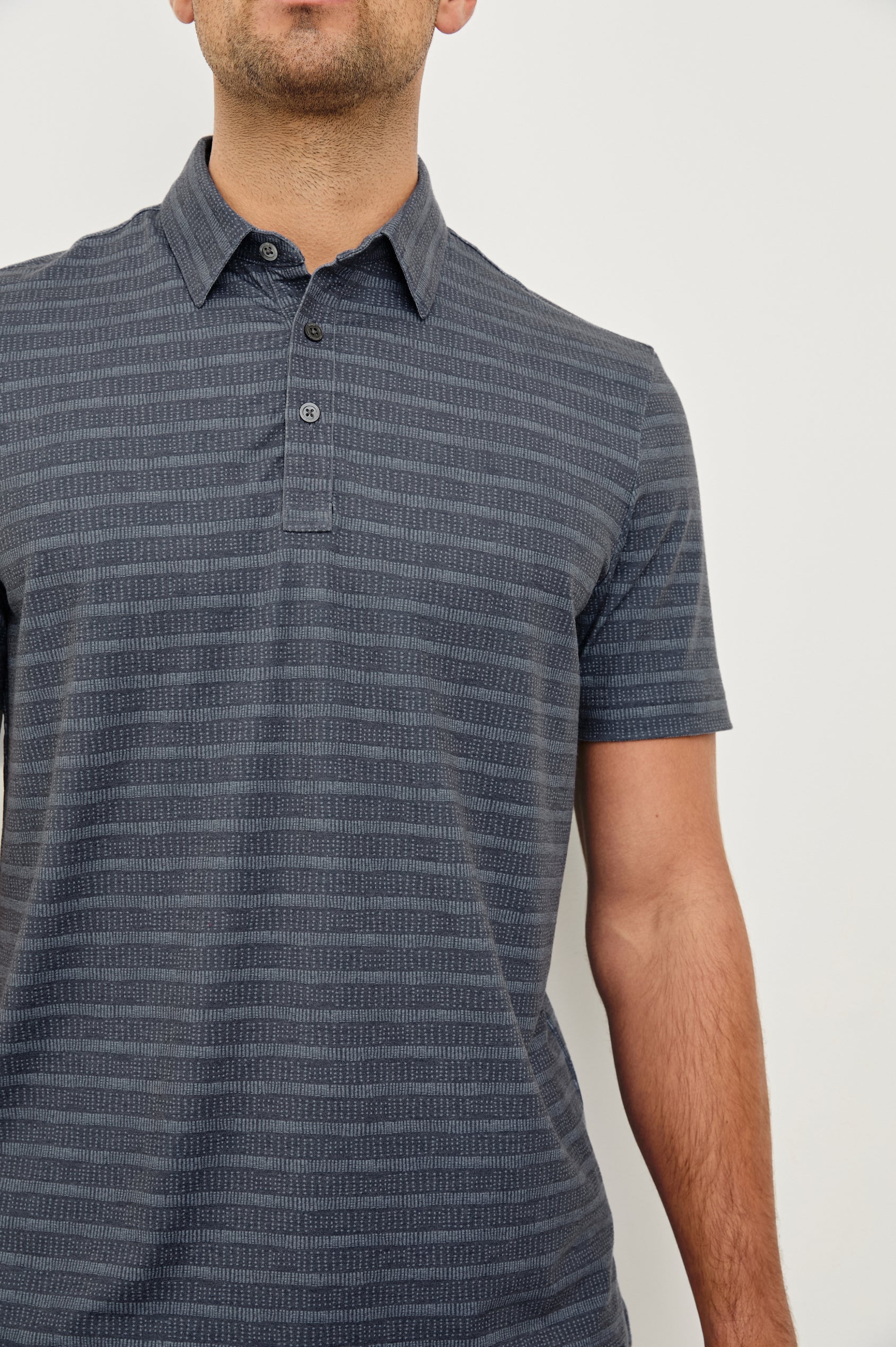 Merced short sleeve athletic Golf Polo with two button placket and collar in Sashiko Border Black - close up of details on model