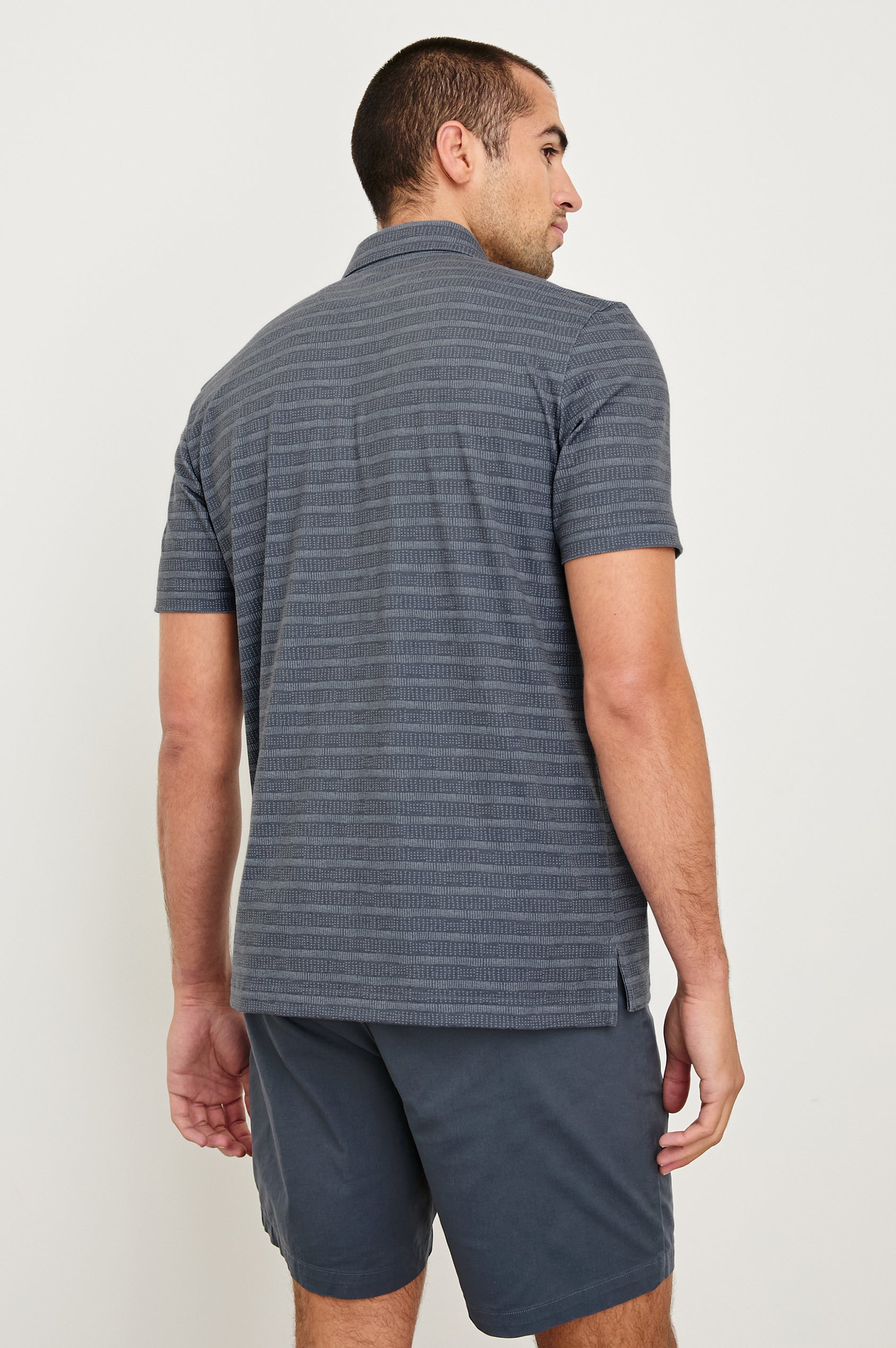 Merced short sleeve athletic Golf Polo with two button placket and collar in Sashiko Border Black - back view on model