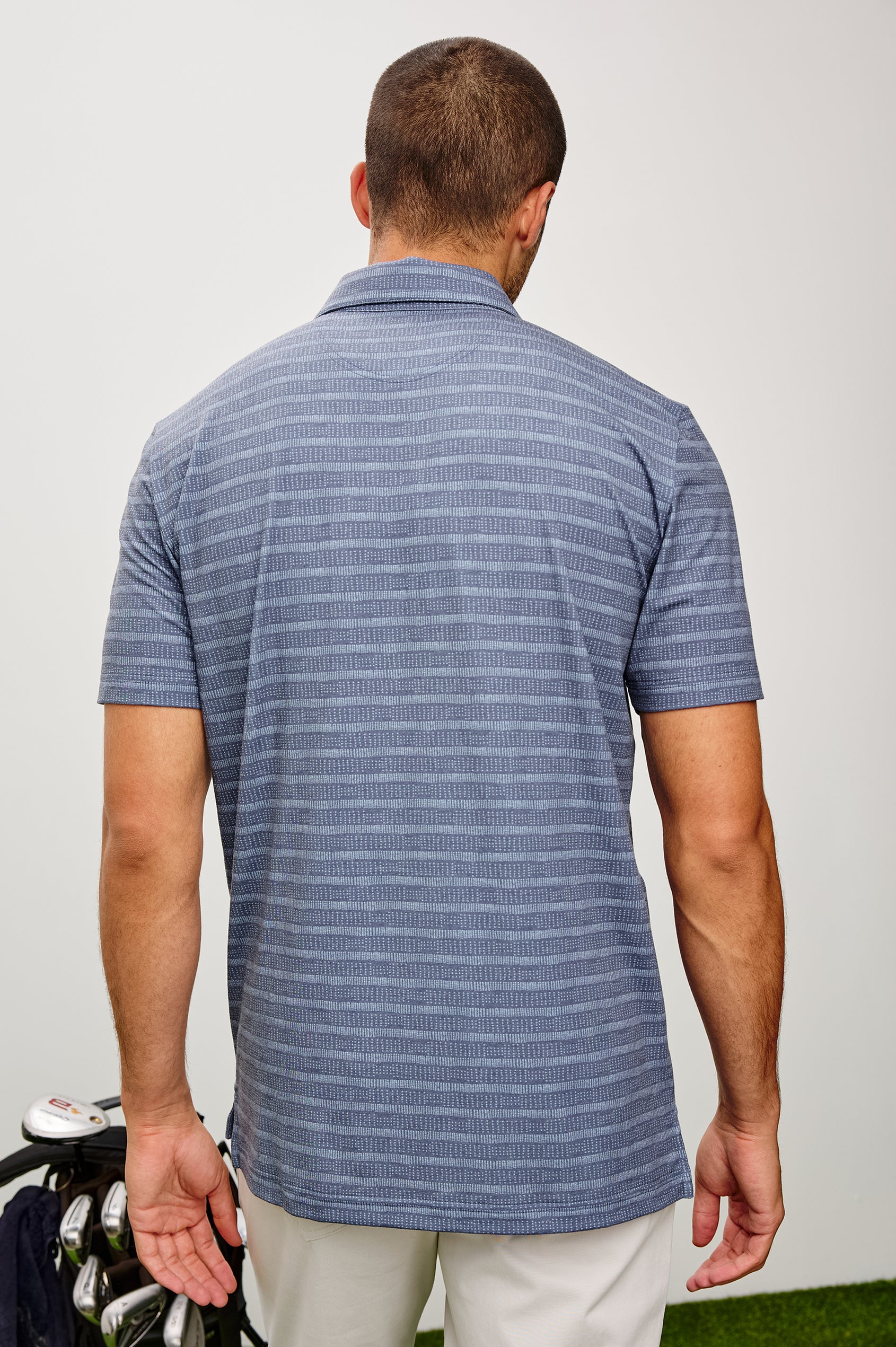 Merced Golf Polo in TENCEL™ Poly Blend With Collar, Quarter Placket, Short Sleeves, and Classic Fit in Hibiscus Mirage Stripe Colorway - Upper Body Back View Featured on Model