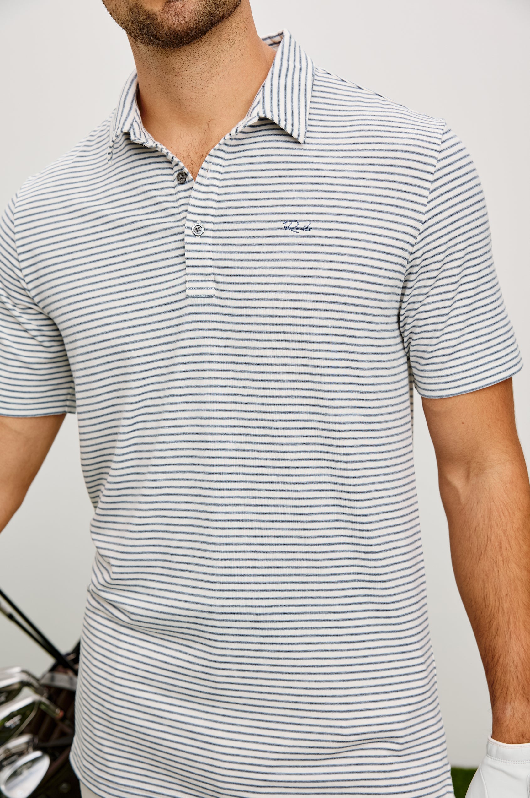 Merced Golf Polo in TENCEL™ Poly Blend With Collar, Quarter Placket, Short Sleeves, and Classic Fit in White Cosmos Stripe Colorway - Upper Body Front View Featured on Model